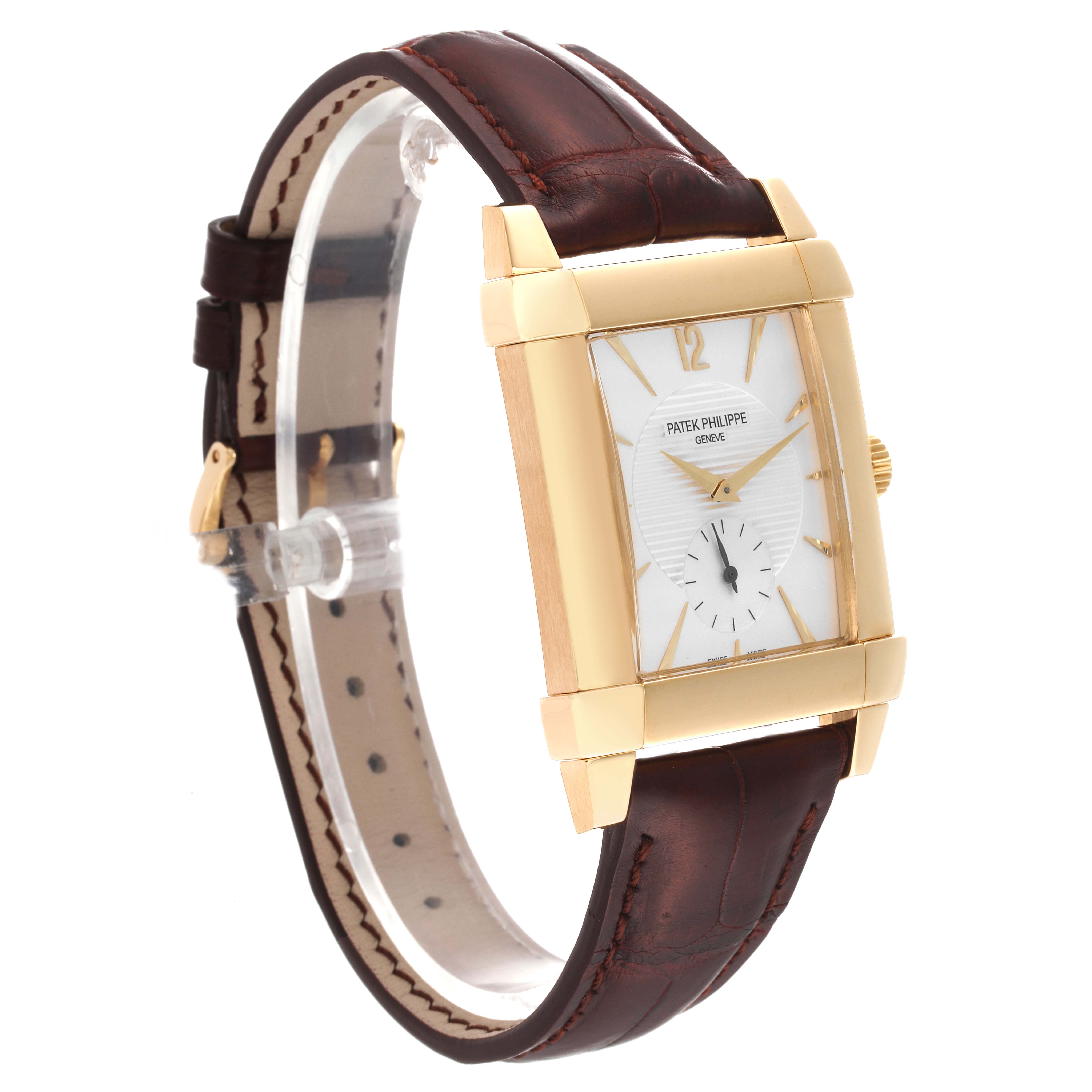 The Patek Philippe Gondolo 5111J Men's Yellow Gold Silver Dial 5111J Men's Yellow Gold Silver Dial watch is shown at a three-quarter angle, highlighting its gold case, white dial, and brown leather strap.