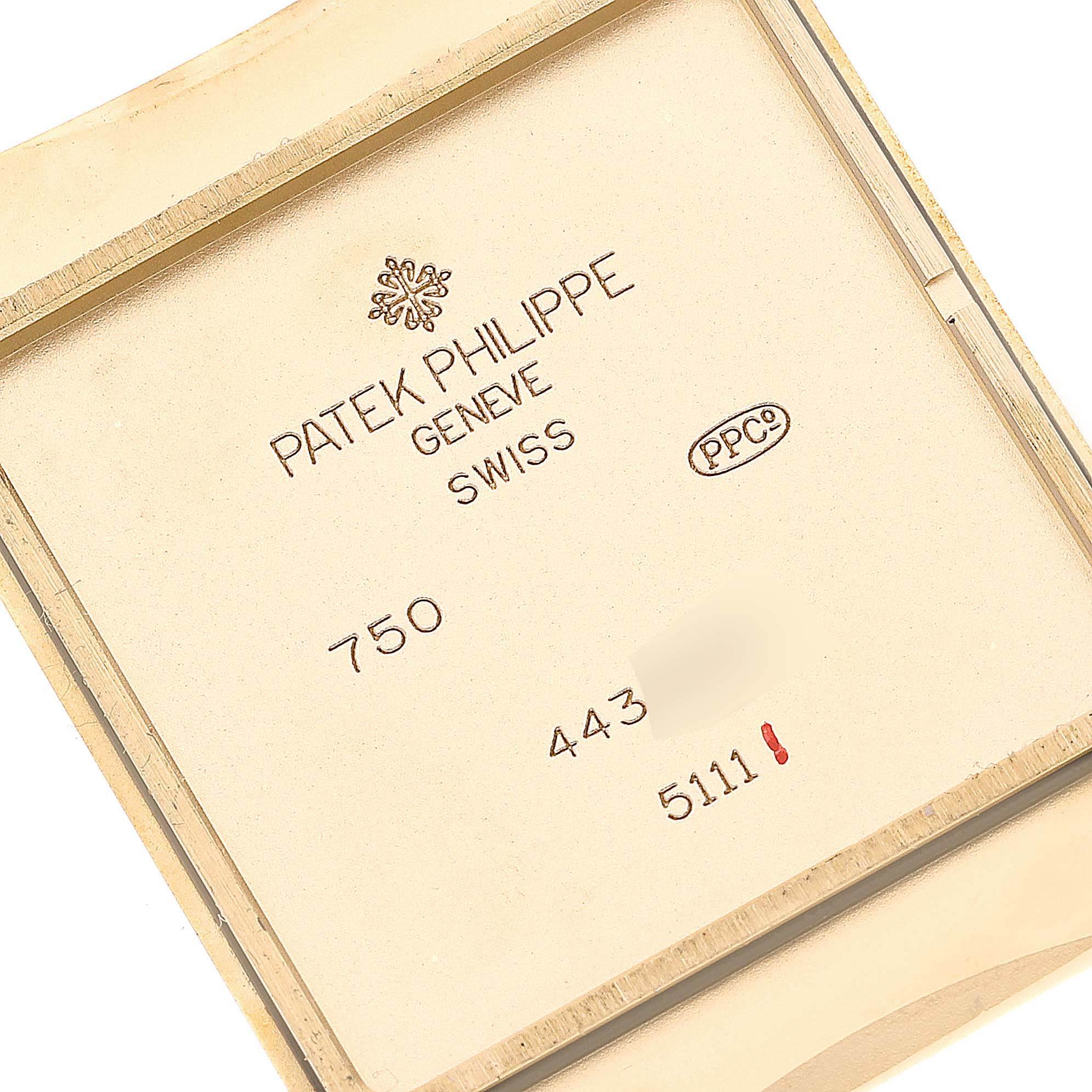 This image shows the inside case back of a Patek Philippe Gondolo 5111J Men's Yellow Gold Silver Dial 5111J Men's Yellow Gold Silver Dial model watch, displaying the brand details and model numbers.