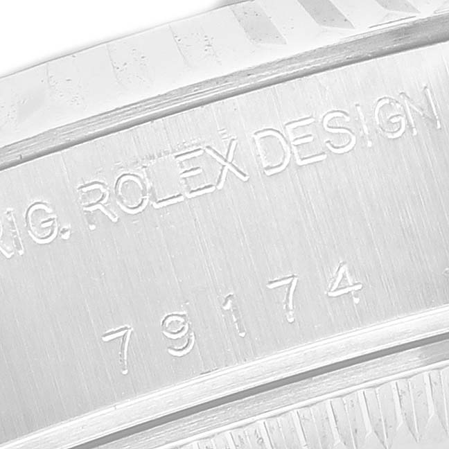 The image shows a close-up of the engraved side of the bezel on a Rolex Datejust 79174 Men's Stainless Steel Mother of Pearl Dial watch.