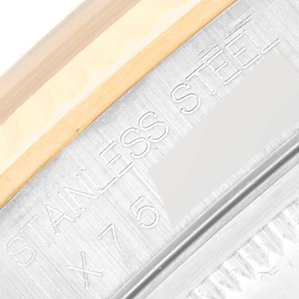 This image shows a close-up of the side of a Rolex Datejust 16233 Men's Steel and Gold (two tone) Champagne Dial 16233 Men's Steel and Gold (two tone) Champagne Dial watch, highlighting its stainless steel and gold components.