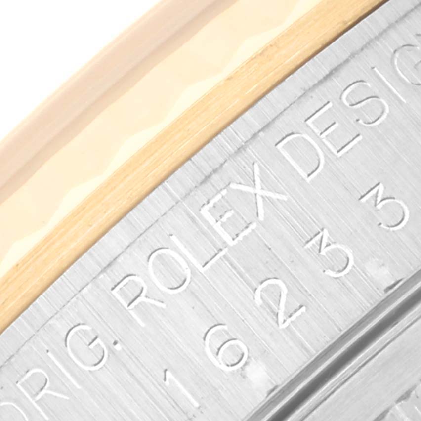 This is a close-up of the inner bezel of a Rolex Datejust 16233 Men's Steel and Gold (two tone) Silver Dial 16233 Men's Steel and Gold (two tone) Silver Dial watch, showing the engraved branding and model number.