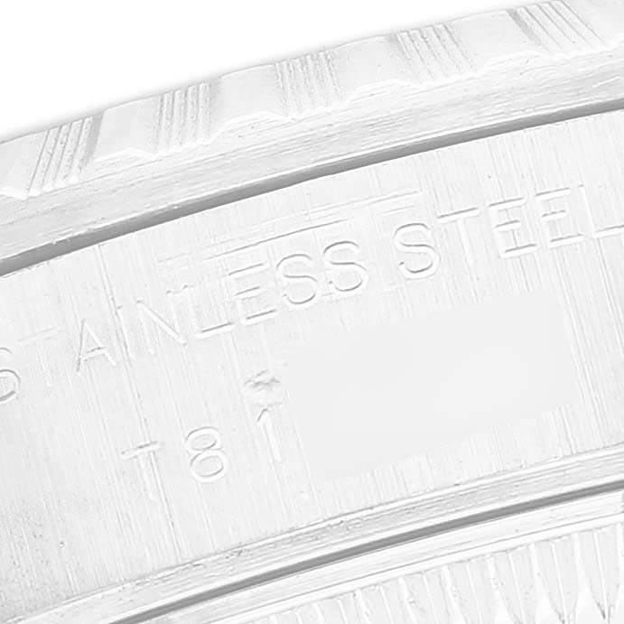 The image shows a close-up of the engraved text on the case back of a Rolex Datejust 69240 Men's Stainless Steel Blue Dial watch, focusing on "STAINLESS STEEL."
