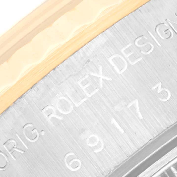 This image shows a close-up of the side engraving on the Rolex Datejust 69173 Women's Steel and Gold (two tone) Blue Dial 69173 Women's Steel and Gold (two tone) Blue Dial watch case, detailing "ROLEX DESIGN."