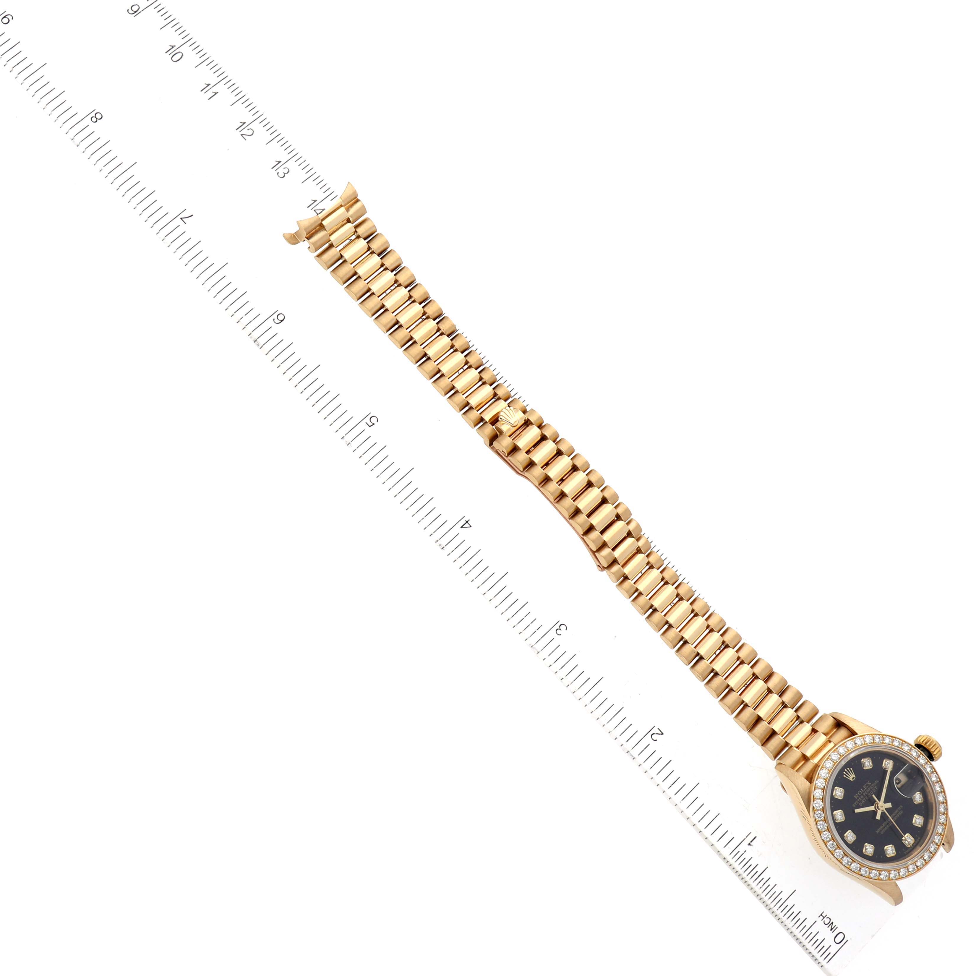 The Rolex President 69138 Women's Yellow Gold Black Dial 69138 Women's Yellow Gold Black Dial model watch shown is laid flat with the entire bracelet and face visible.