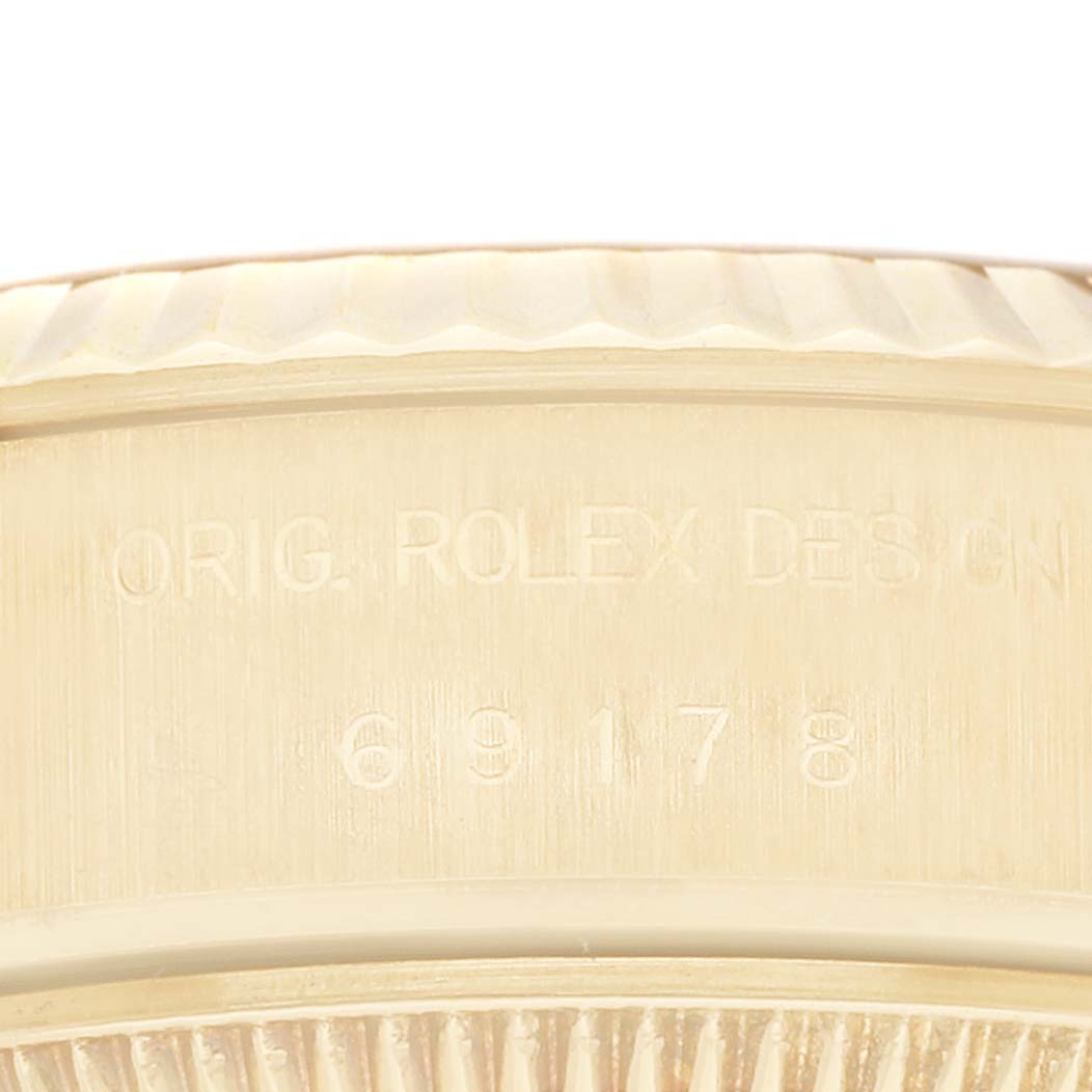This image shows the side view of the case back of a Rolex President 69178 Women
s Yellow Gold Champagne Dial 69178 Women
s Yellow Gold Champagne Dial model watch, displaying part of its engraving and model number.