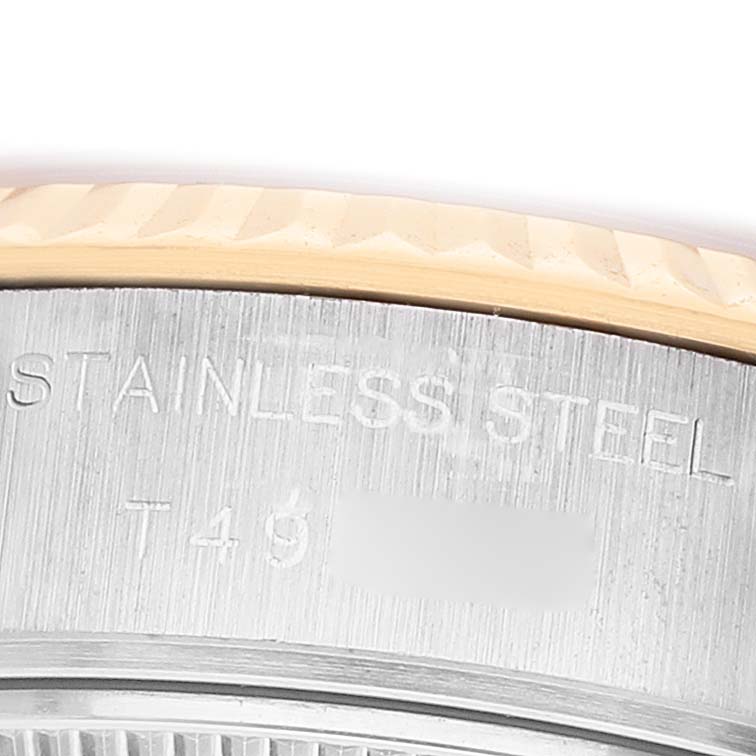 The image shows a close-up of the Rolex Datejust 69173 Women's Steel and Gold (two tone) Black Dial model's stainless steel side with engraving details.