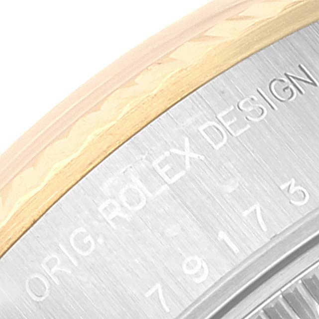 This image shows a close-up of the watch case side on a Rolex Datejust 79173 Women's Steel and Gold (two tone) Beige Dial 79173 Women's Steel and Gold (two tone) Beige Dial, highlighting the engraving and bezel detail.