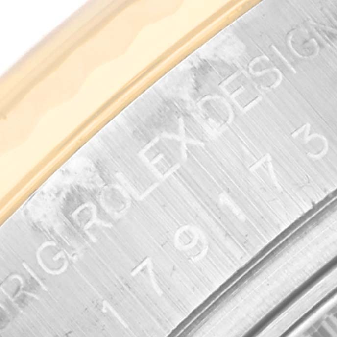 This close-up image shows the engraved edge of a Rolex Datejust 179173 Women's Steel and Gold (two tone) Grey Dial 179173 Women's Steel and Gold (two tone) Grey Dial watch bezel.