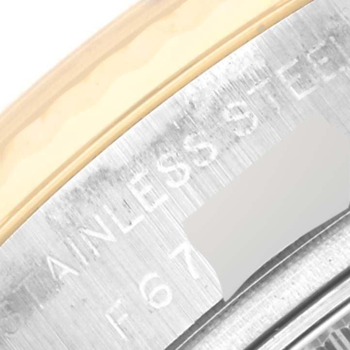 This image shows a close-up of the stainless steel and gold bezel of a Rolex Datejust 179173 Women's Steel and Gold (two tone) Grey Dial 179173 Women's Steel and Gold (two tone) Grey Dial watch.