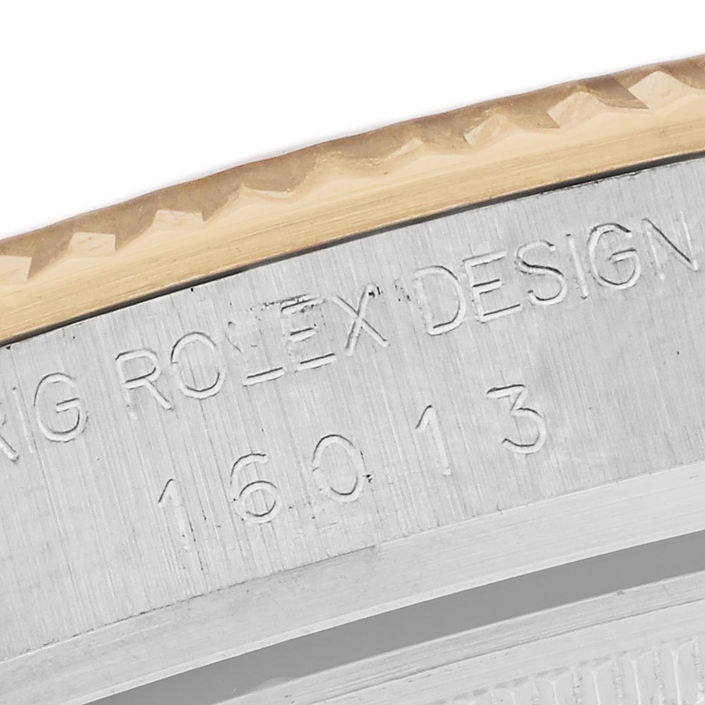 The image shows a close-up of the Rolex Datejust 16013 Men's Steel and Gold (two tone) Champagne Dial 16013 Men's Steel and Gold (two tone) Champagne Dial model’s outer rim, highlighting the engraved design details and serial number.