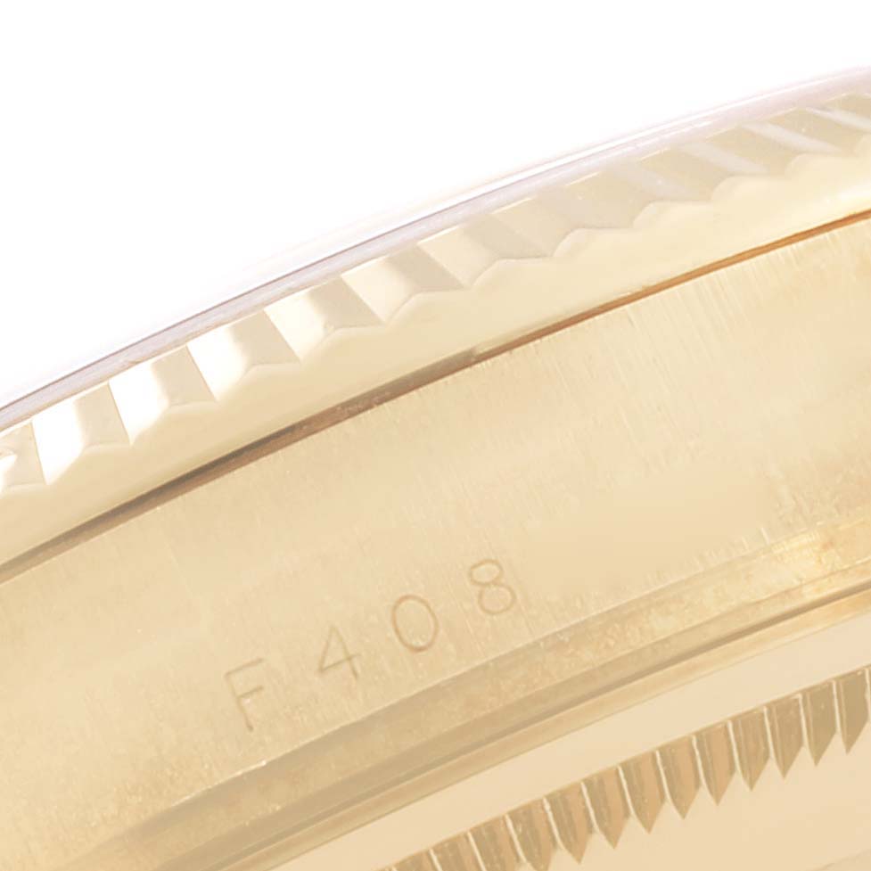This close-up shows the fluted bezel and part of the case of a Rolex President 118238 Men's Yellow Gold Champagne Dial 118238 Men's Yellow Gold Champagne Dial model watch.