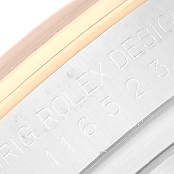 This close-up image shows the engraved model number on the side of the case of a Rolex Daytona 116523 Men
s Steel and Gold (two tone) Black Dial 116523 Men
s Steel and Gold (two tone) Black Dial watch.