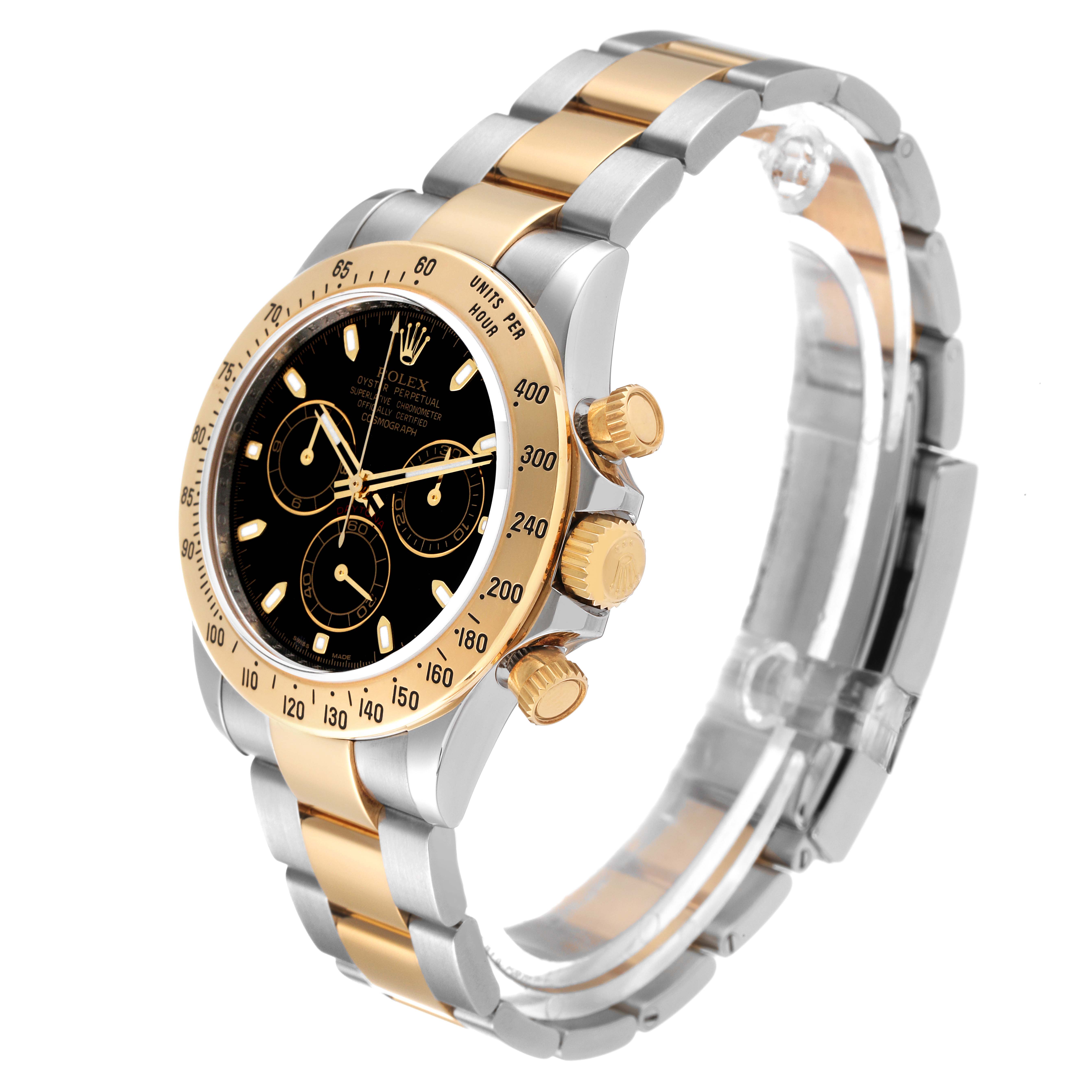The Rolex Daytona 116523 Men
s Steel and Gold (two tone) Black Dial 116523 Men
s Steel and Gold (two tone) Black Dial watch is shown from an angle highlighting its black dial, gold and silver bracelet, and chronograph buttons.