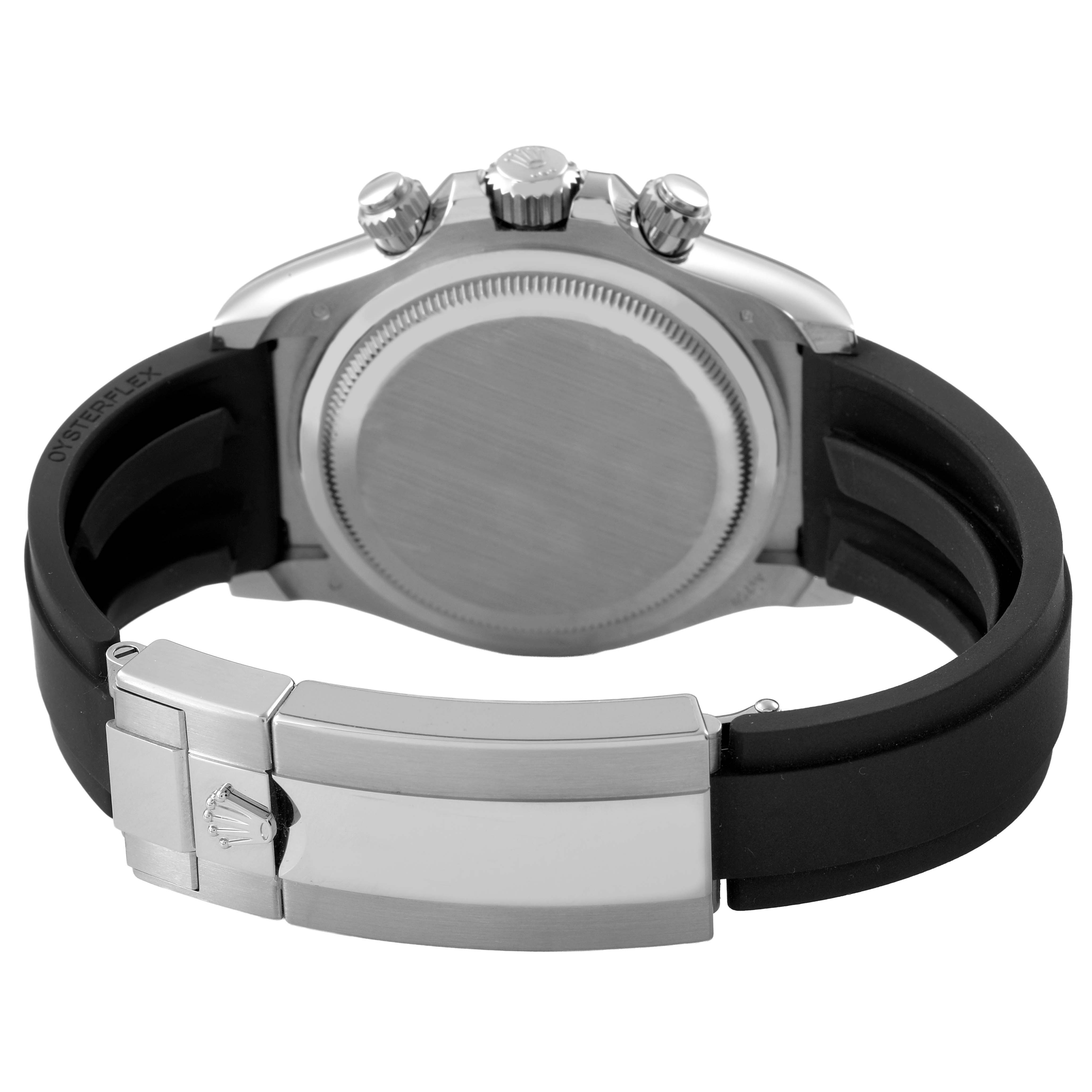 The image shows the back view of a Rolex Daytona 126519LN Men's White Gold Black Dial watch, highlighting the clasp, rubber strap, and crown.