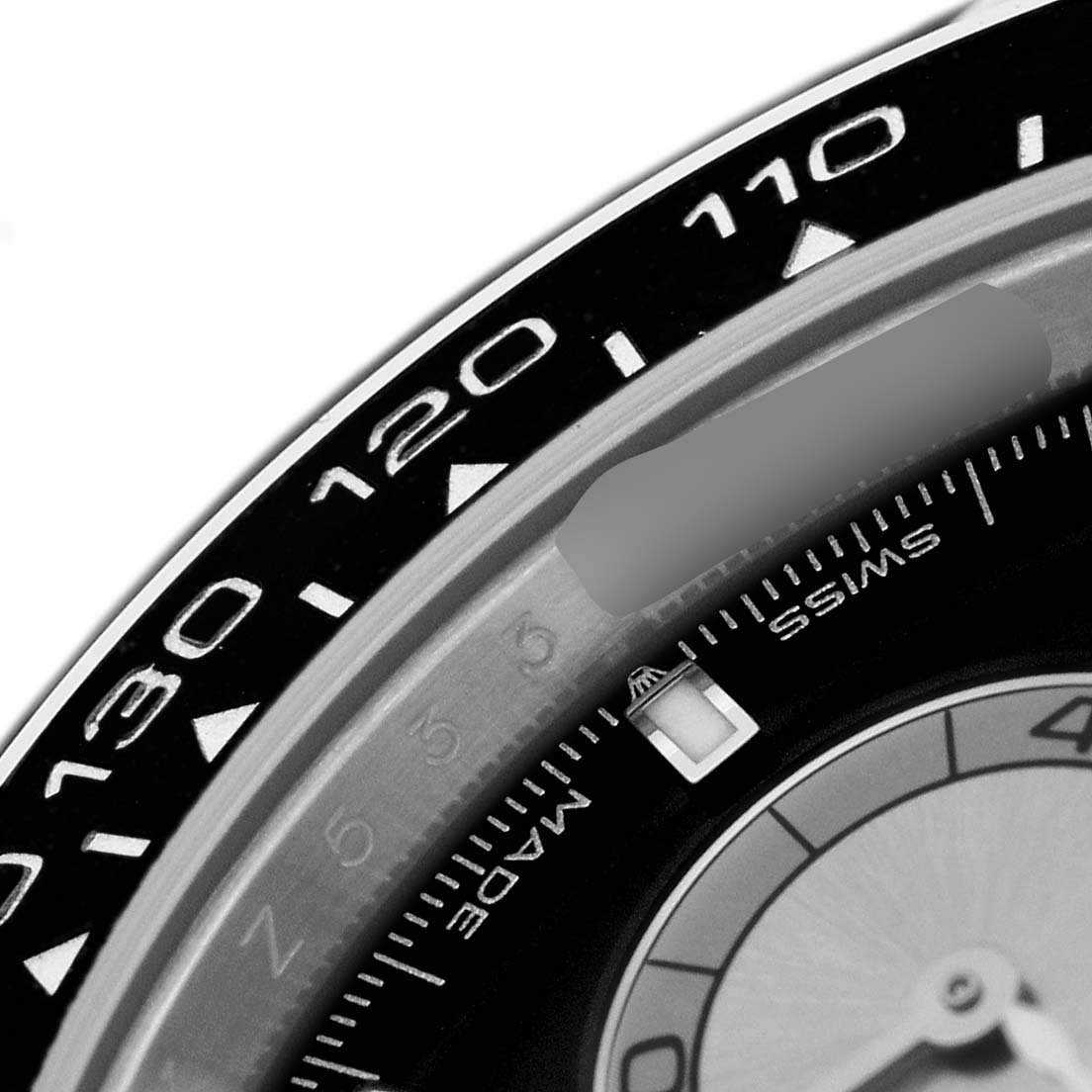 The image shows a close-up of the bezel and edge of the dial of a Rolex Daytona 126519LN Men's White Gold Black Dial watch, emphasizing the tachymetric scale.