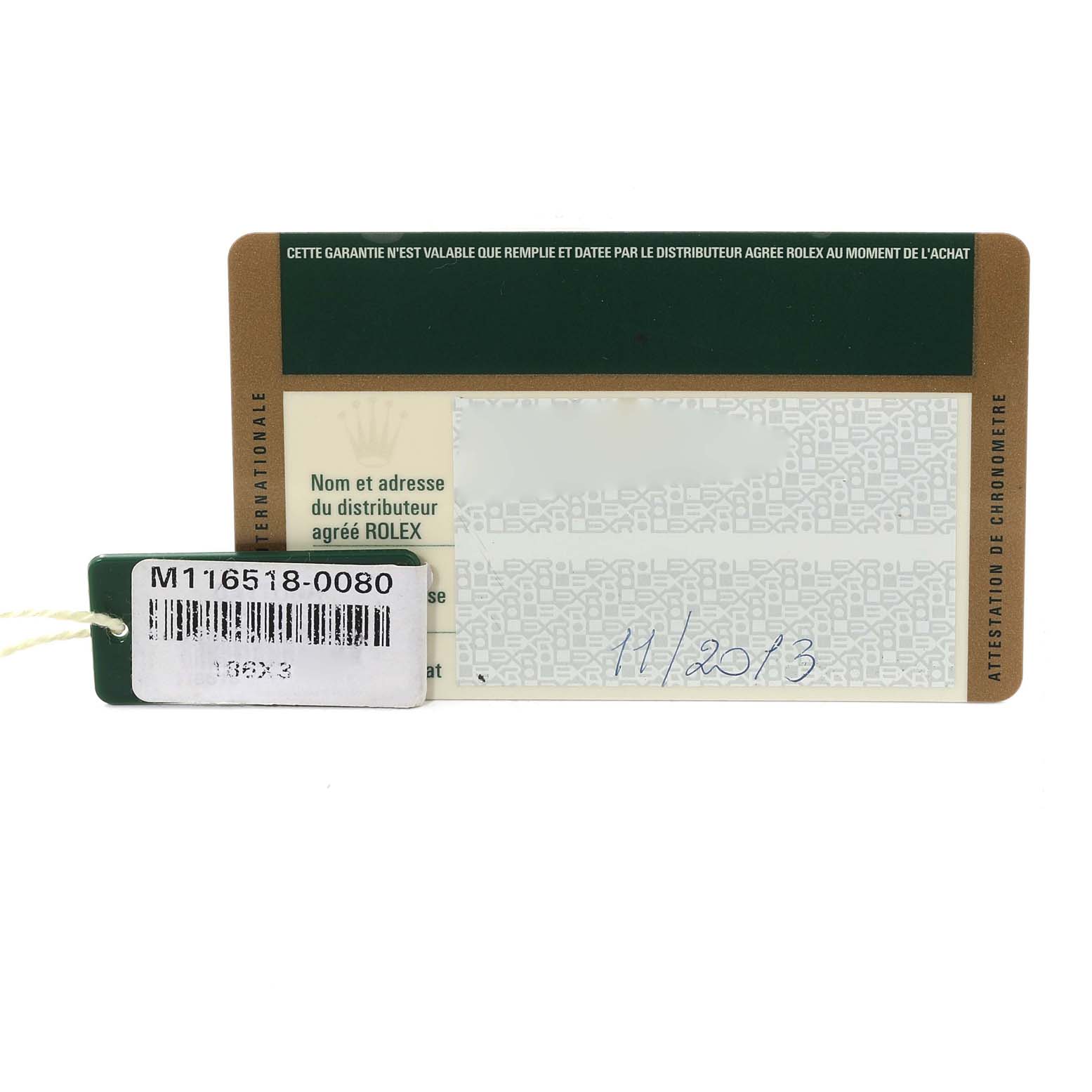 The image shows the warranty card and tag of a Rolex Daytona M116518-0080 Men's Yellow Gold Black Dial M116518-0080 Men's Yellow Gold Black Dial watch model M116518-0080, with the date handwritten as 11/2013.