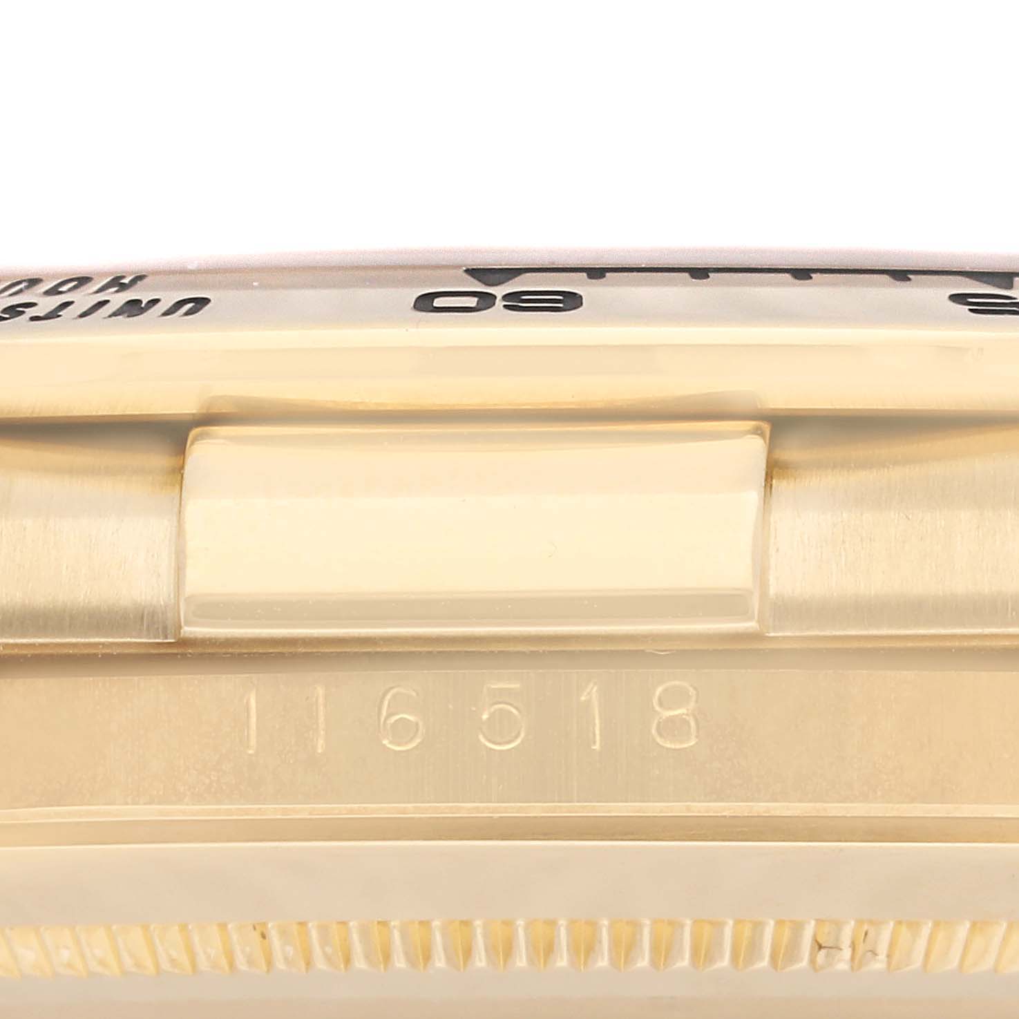 The image shows a side view of the serial number 116518 on the case and part of the bezel of a Rolex Daytona M116518-0080 Men's Yellow Gold Black Dial M116518-0080 Men's Yellow Gold Black Dial watch.