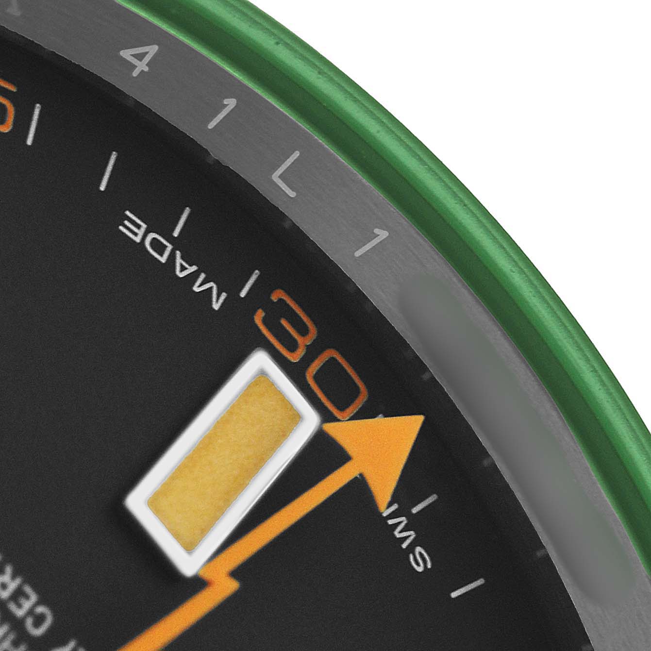 The image shows a close-up of the dial and bezel of a Rolex Milgauss M116400GV-0001 Men's Stainless Steel Black Dial, highlighting the orange seconds hand and "30" minute mark.