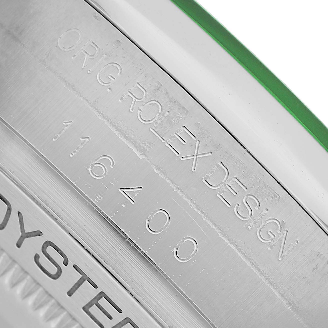 The image shows a close-up of the side engraving on the Rolex Milgauss M116400GV-0001 Men's Stainless Steel Black Dial watch, highlighting design details and model number.