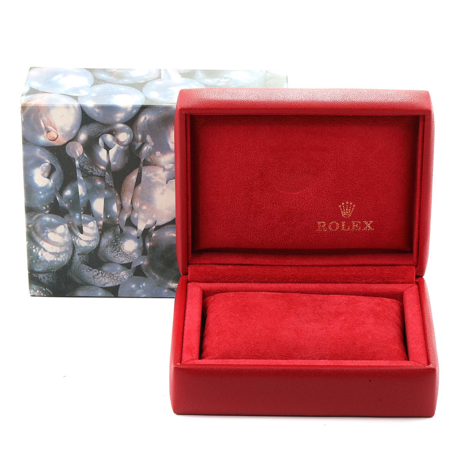 The image shows an open red Rolex box with the lid lifted, used for the Oyster Perpetual model, accompanied by its outer packaging.