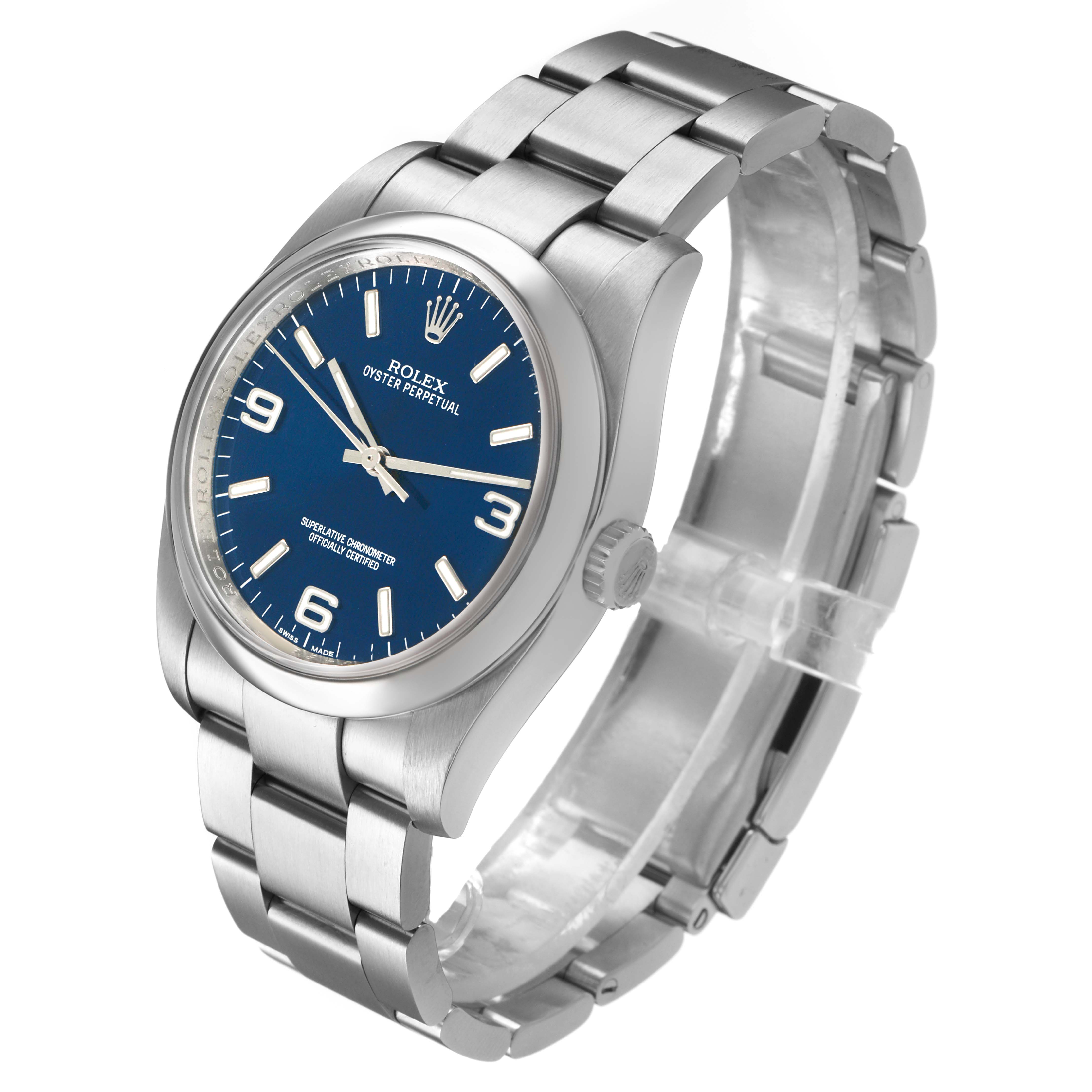 The Rolex Oyster Perpetual 116000 Men's Stainless Steel Blue Dial watch is shown at a three-quarter angle, highlighting the face, crown, and stainless steel bracelet.
