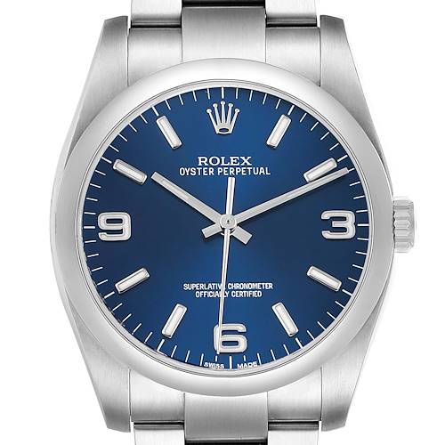 The Rolex Oyster Perpetual 116000 Men's Stainless Steel Blue Dial watch is shown from the front, highlighting the dial, hour markers, case, and a portion of the bracelet.