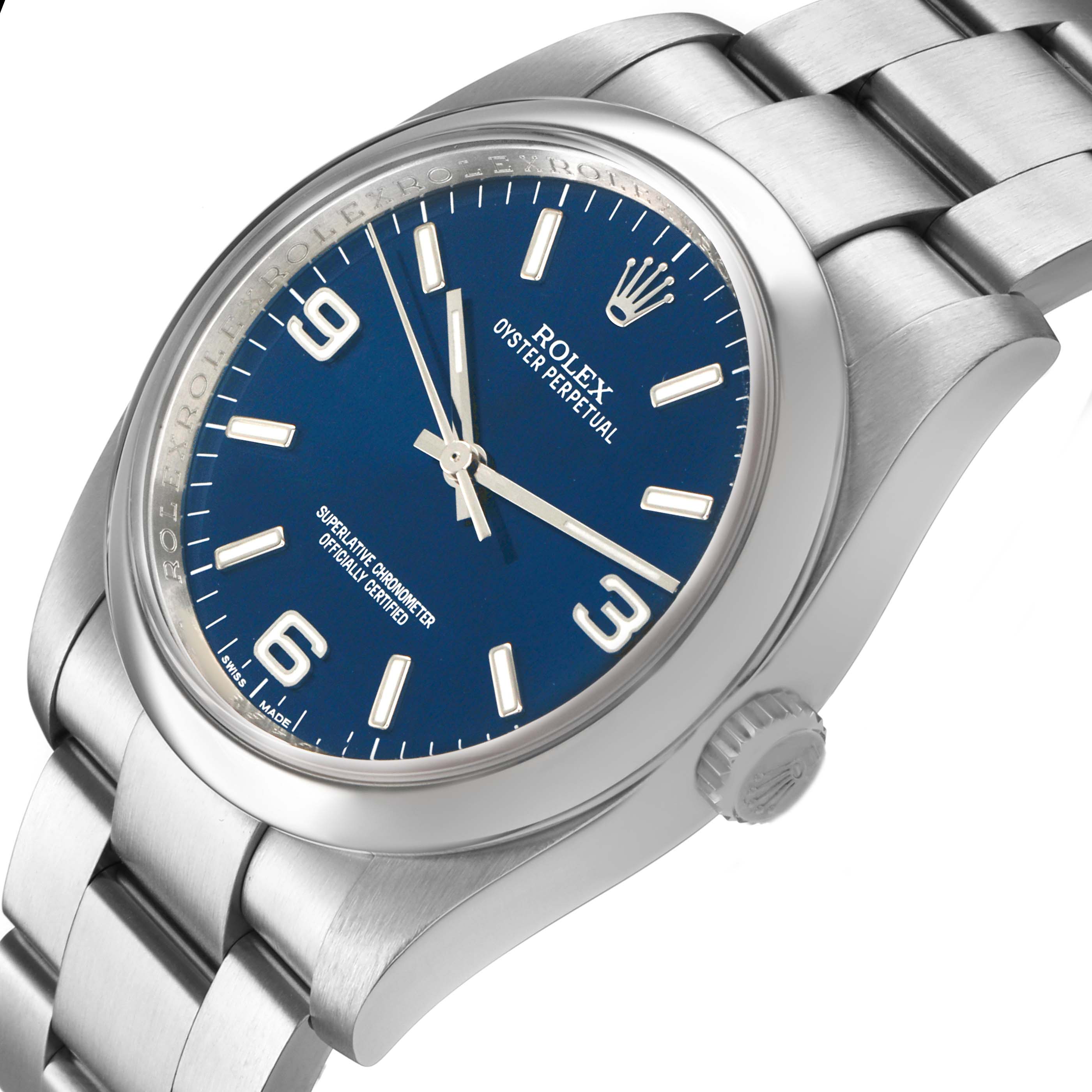 The Rolex Oyster Perpetual 116000 Men's Stainless Steel Blue Dial watch is shown at an angled view highlighting the blue dial, bezel, crown, and part of the bracelet.