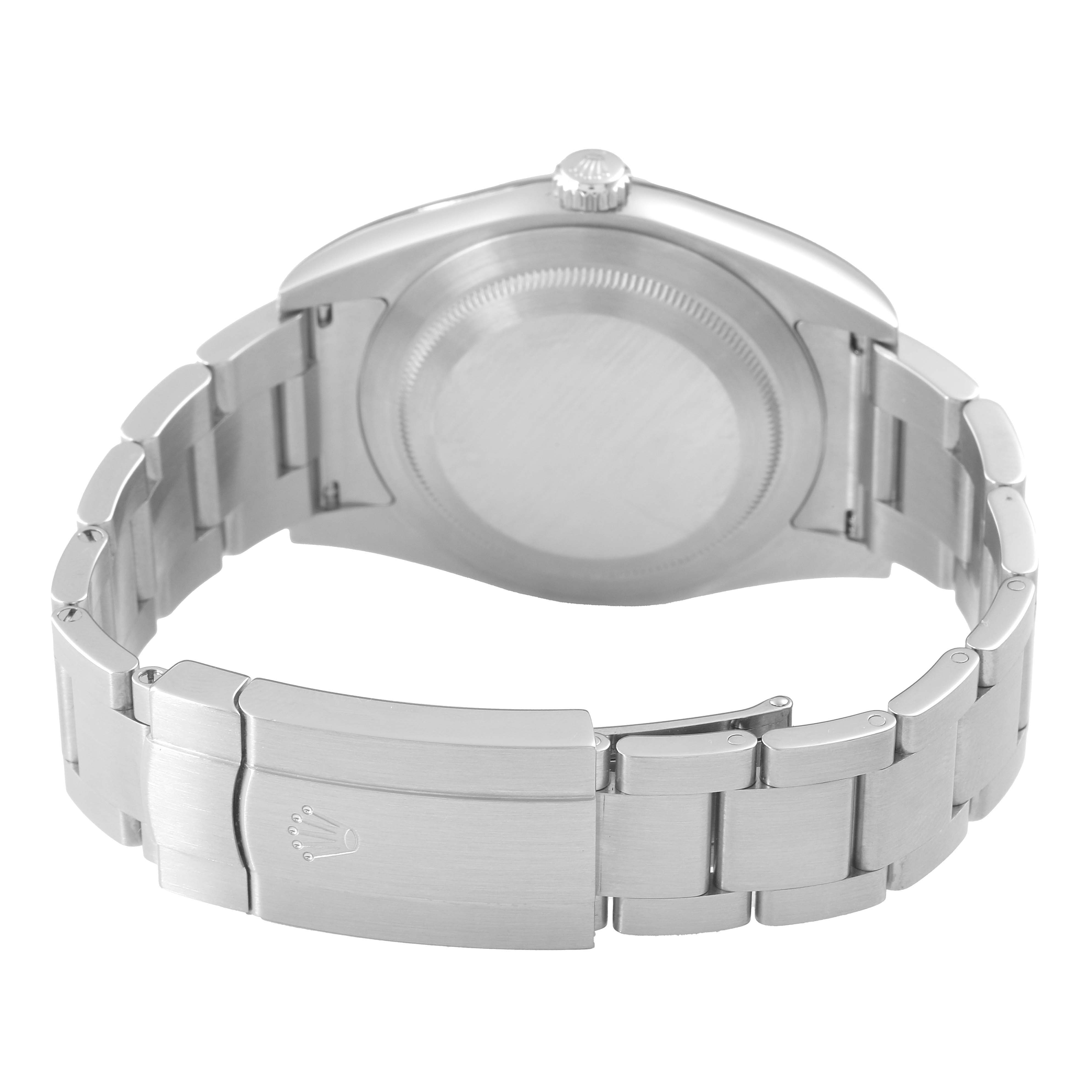 The image shows a rear angle of a Rolex Oyster Perpetual 114300 Men's Stainless Steel Blue Dial, focusing on its case back, crown, and bracelet clasp.