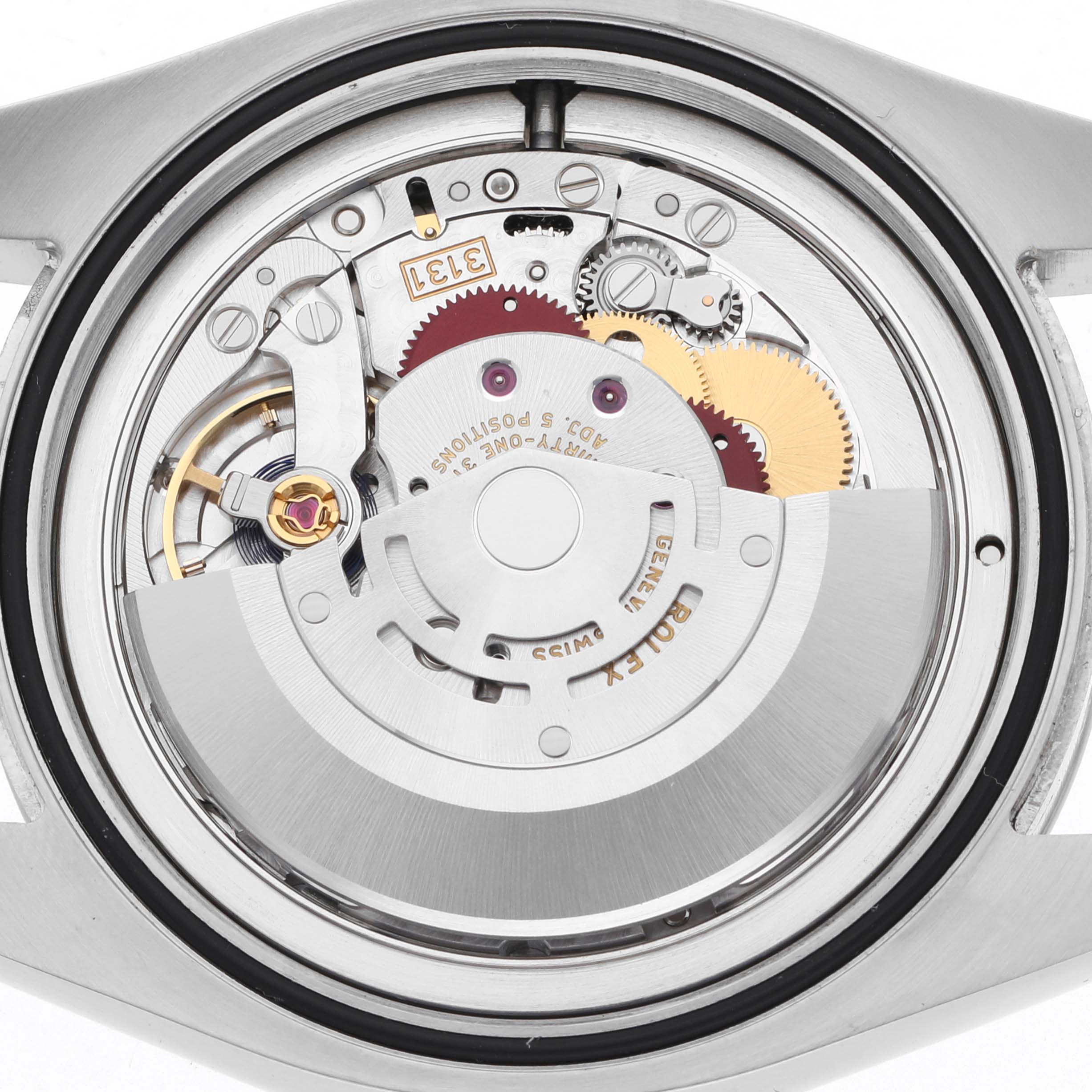 The image shows the movement of a Rolex Air-King 116900 Men's Stainless Steel Black Dial 116900 Men's Stainless Steel Black Dial watch viewed from the back, highlighting gears and rotor details.
