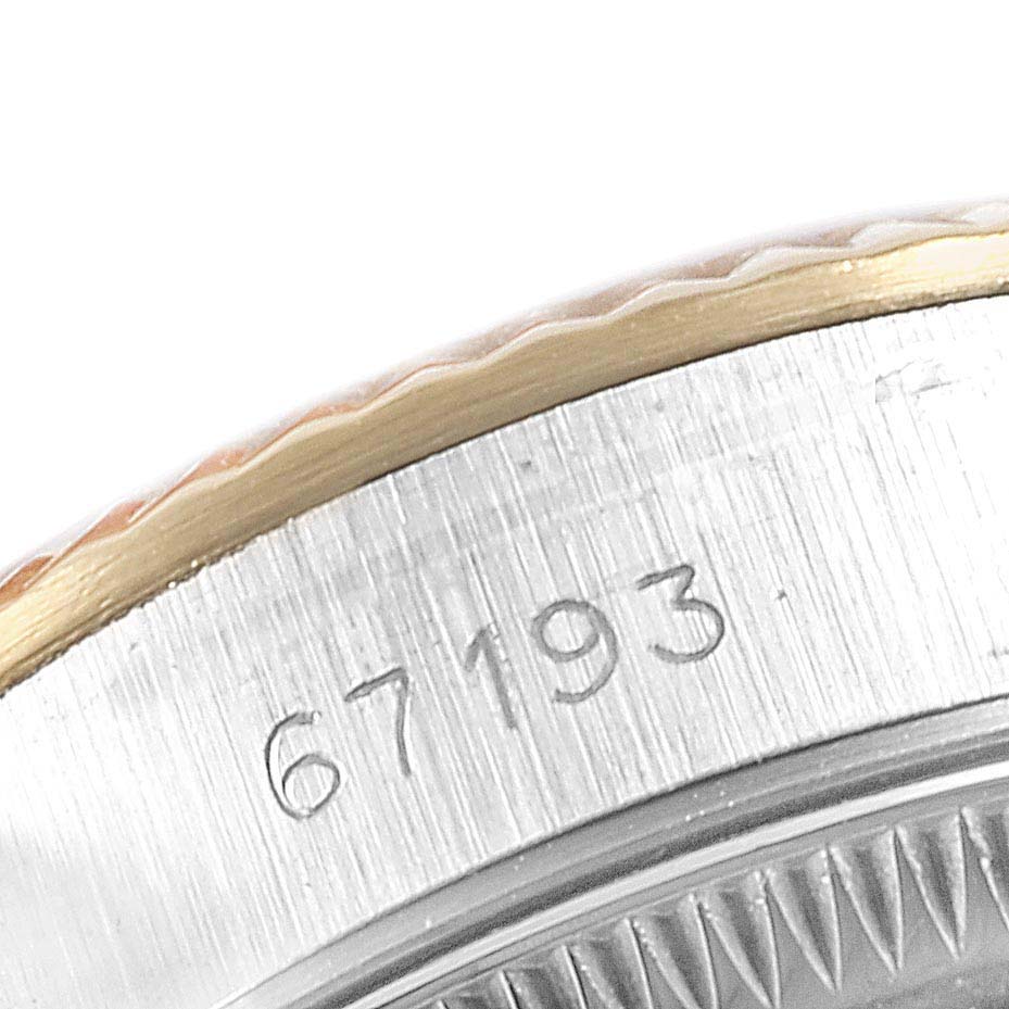 This close-up image of a Rolex 67193 Women
s Steel and Gold (two tone) Champagne Dial 67193 Women
s Steel and Gold (two tone) Champagne Dial Oyster Perpetual Steel Yellow Gold Ladies Watch 67193 model shows part of the bezel and the engraved model number.