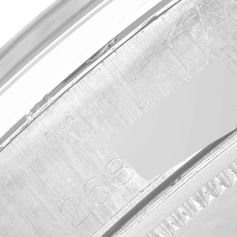 This image shows a close-up view of the serial number and part of the bezel of the Rolex Vintage Collection 6694 Men's Stainless Steel Blue Dial 6694 Men's Stainless Steel Blue Dial watch.