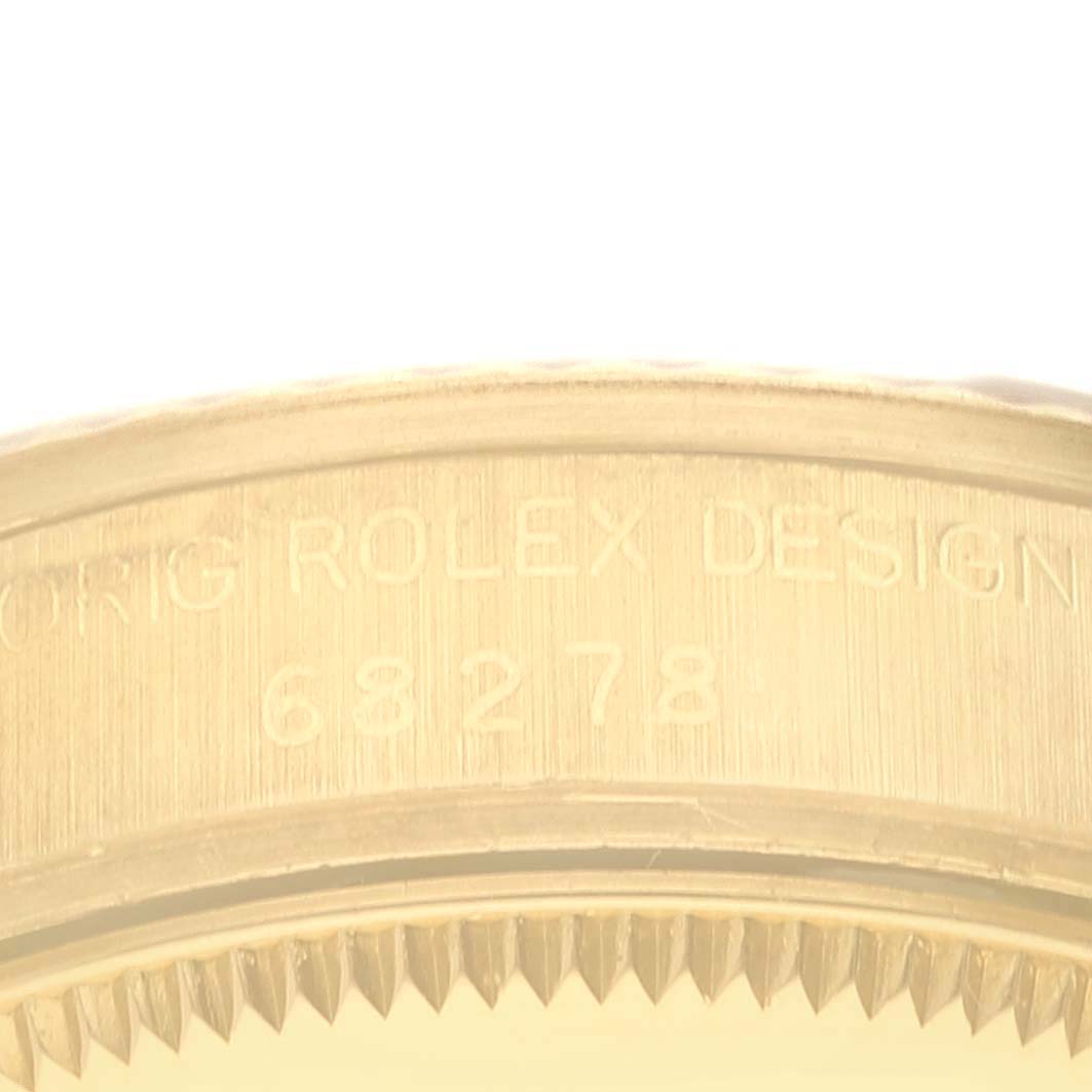 This image shows a close-up of the edge and part of the bezel of a Rolex President 68278 Women
s Yellow Gold Champagne Dial 68278 Women
s Yellow Gold Champagne Dial model watch.