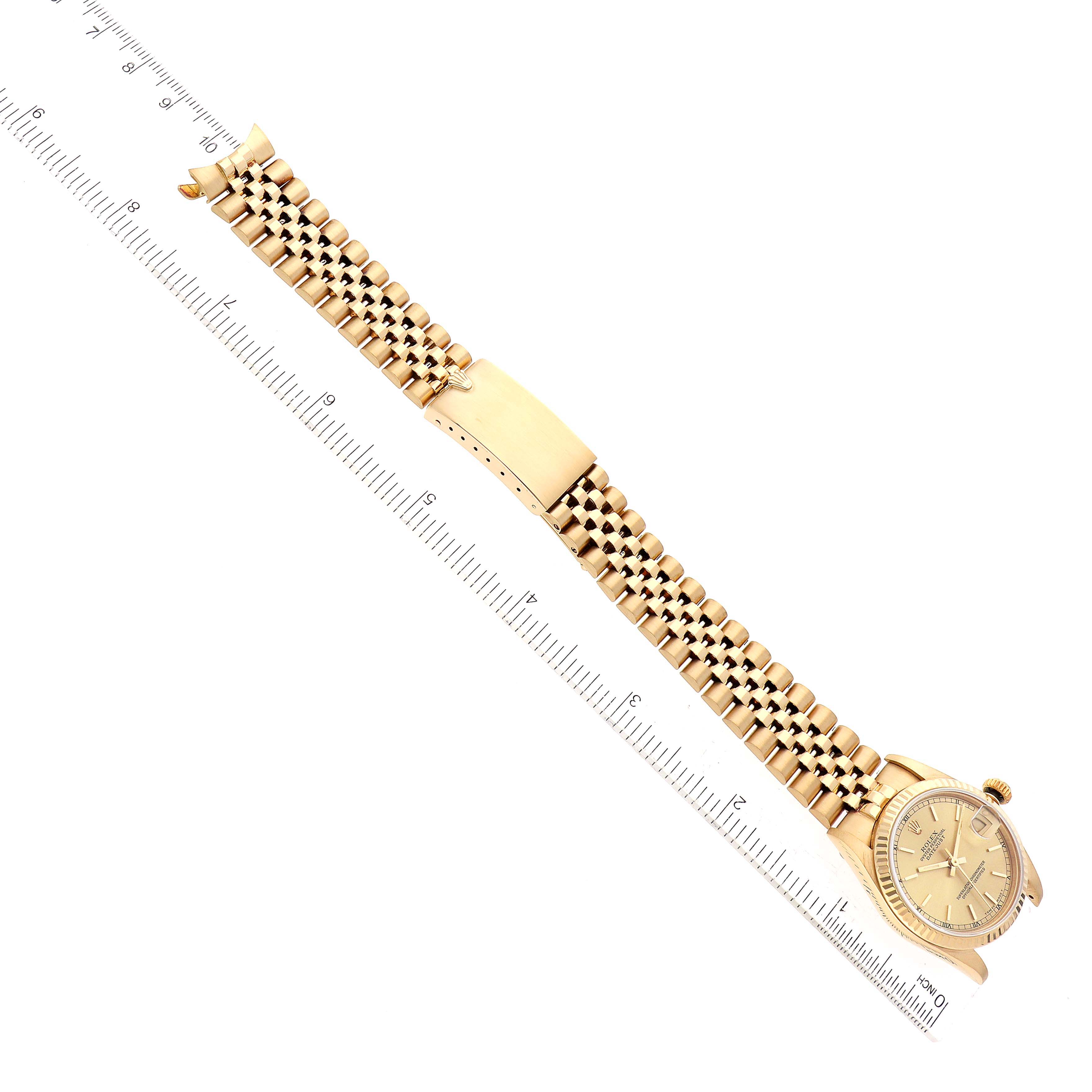The image shows a Rolex President 68278 Women's Yellow Gold Champagne Dial 68278 Women's Yellow Gold Champagne Dial model watch laid flat next to a ruler, displaying the face, bezel, and bracelet.