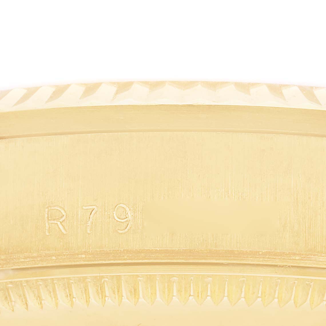 This close-up image shows part of the bezel and the engraved serial number of a Rolex President 68278 Women
s Yellow Gold Champagne Dial 68278 Women
s Yellow Gold Champagne Dial model watch.