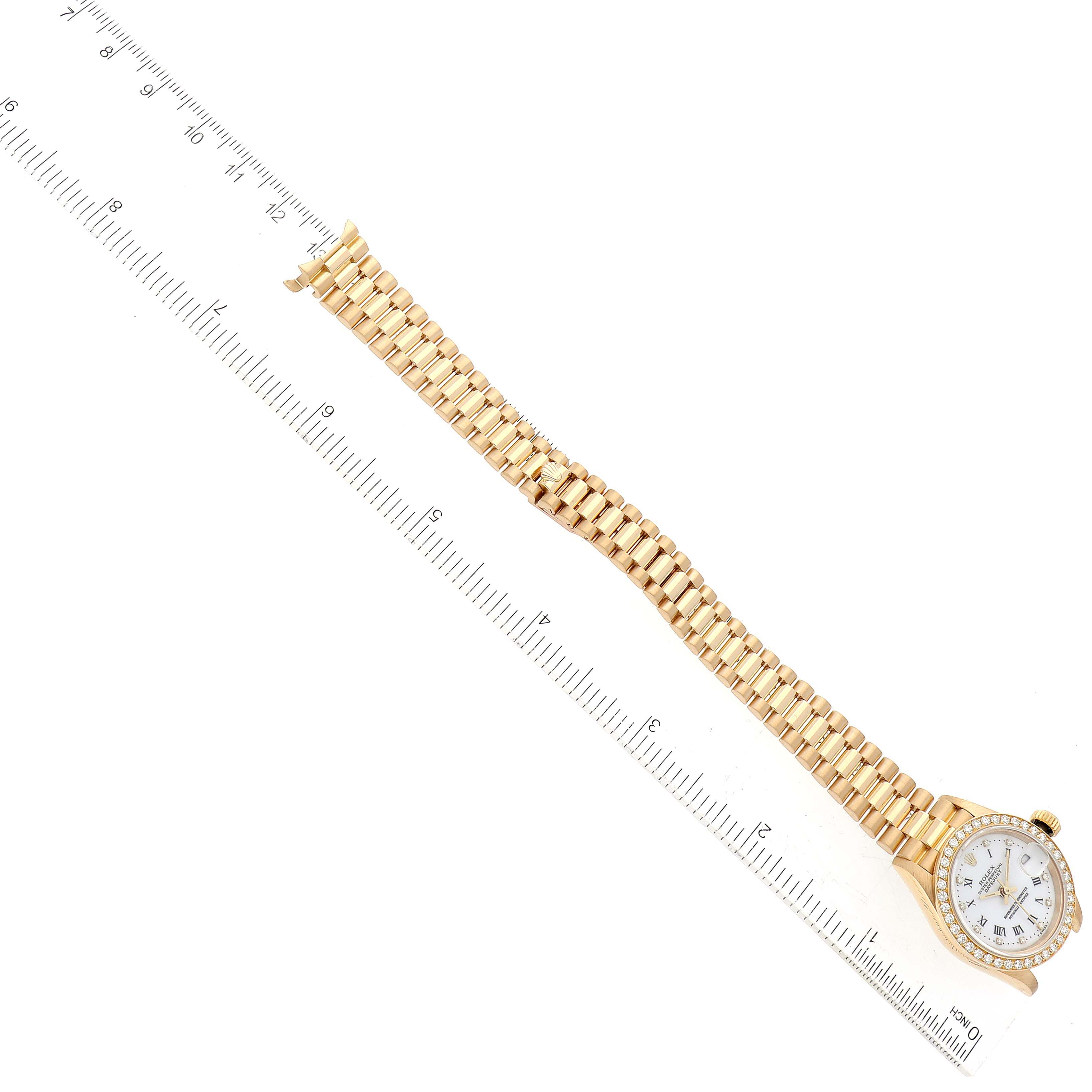 The Rolex President 69138G Women's Yellow Gold White Dial 69138G Women's Yellow Gold White Dial model watch is shown from a top-down angle, displaying the full length of the band and part of the face.