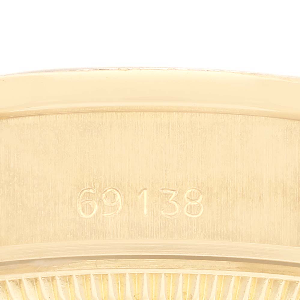 This image shows a close-up of the serial number on a Rolex President 69138G Women's Yellow Gold White Dial 69138G Women's Yellow Gold White Dial model watch.