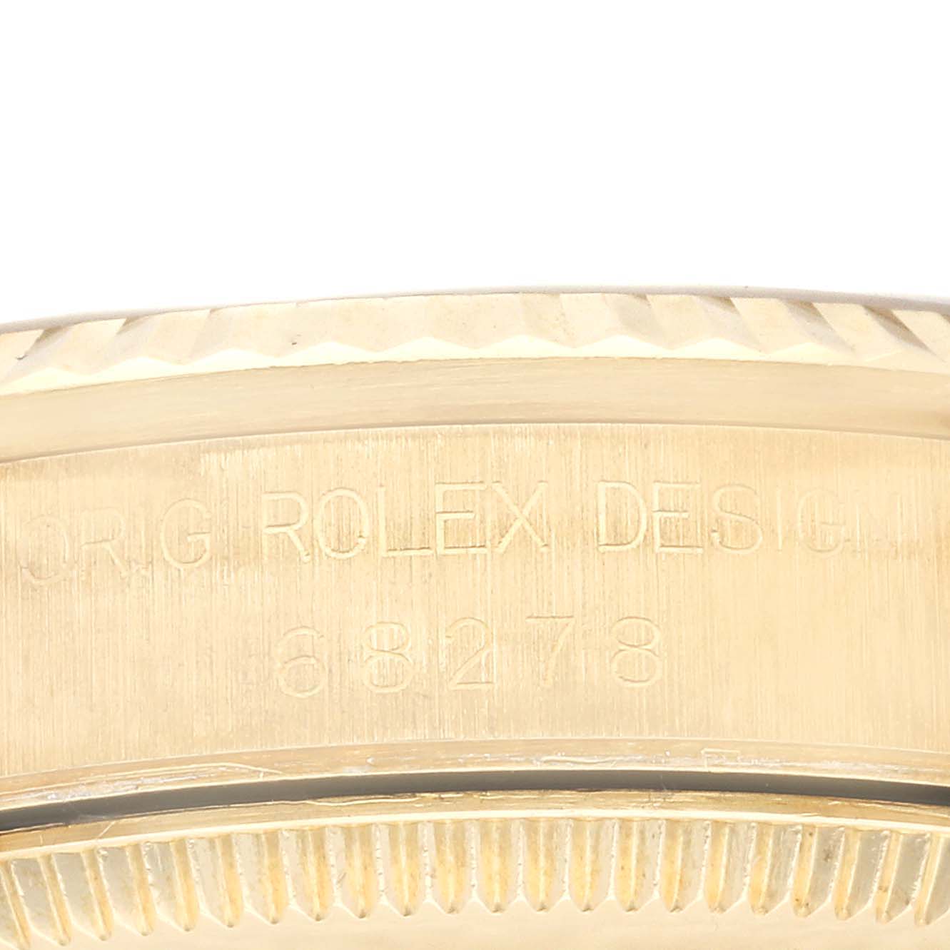 The image shows a close-up of the side of a Rolex President 68278G Women
s Yellow Gold Champagne Dial 68278G Women
s Yellow Gold Champagne Dial model, highlighting the case and design engravings.