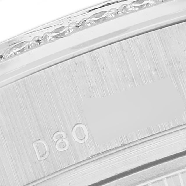 The image shows a close-up of the side of a Rolex President 179136 Women's Platinum Blue Dial 179136 Women's Platinum Blue Dial watch, focusing on the bezel and serial engraving.
