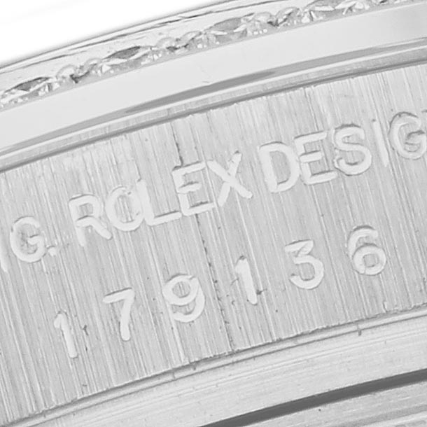 The image shows a close-up of the engraved case side of a Rolex President 179136 Women's Platinum Blue Dial 179136 Women's Platinum Blue Dial model watch with part of its serial number.