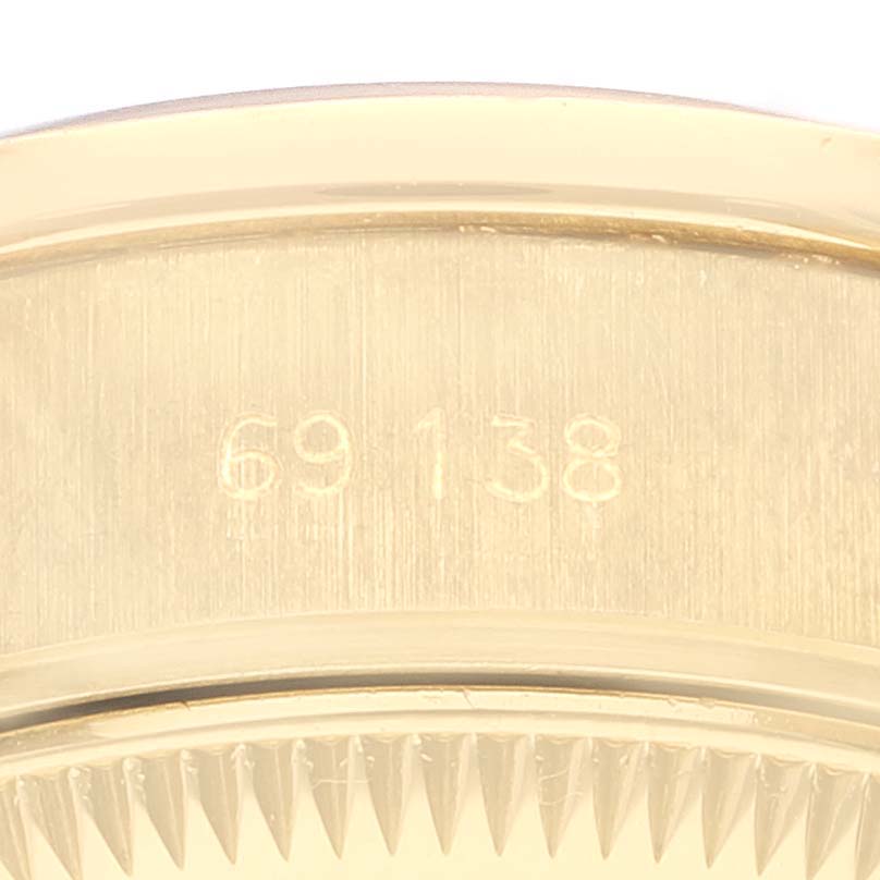 This close-up image shows the reference number and possibly part of the bezel of a Rolex President 69138 Women's Yellow Gold Blue Dial 69138 Women's Yellow Gold Blue Dial model watch.