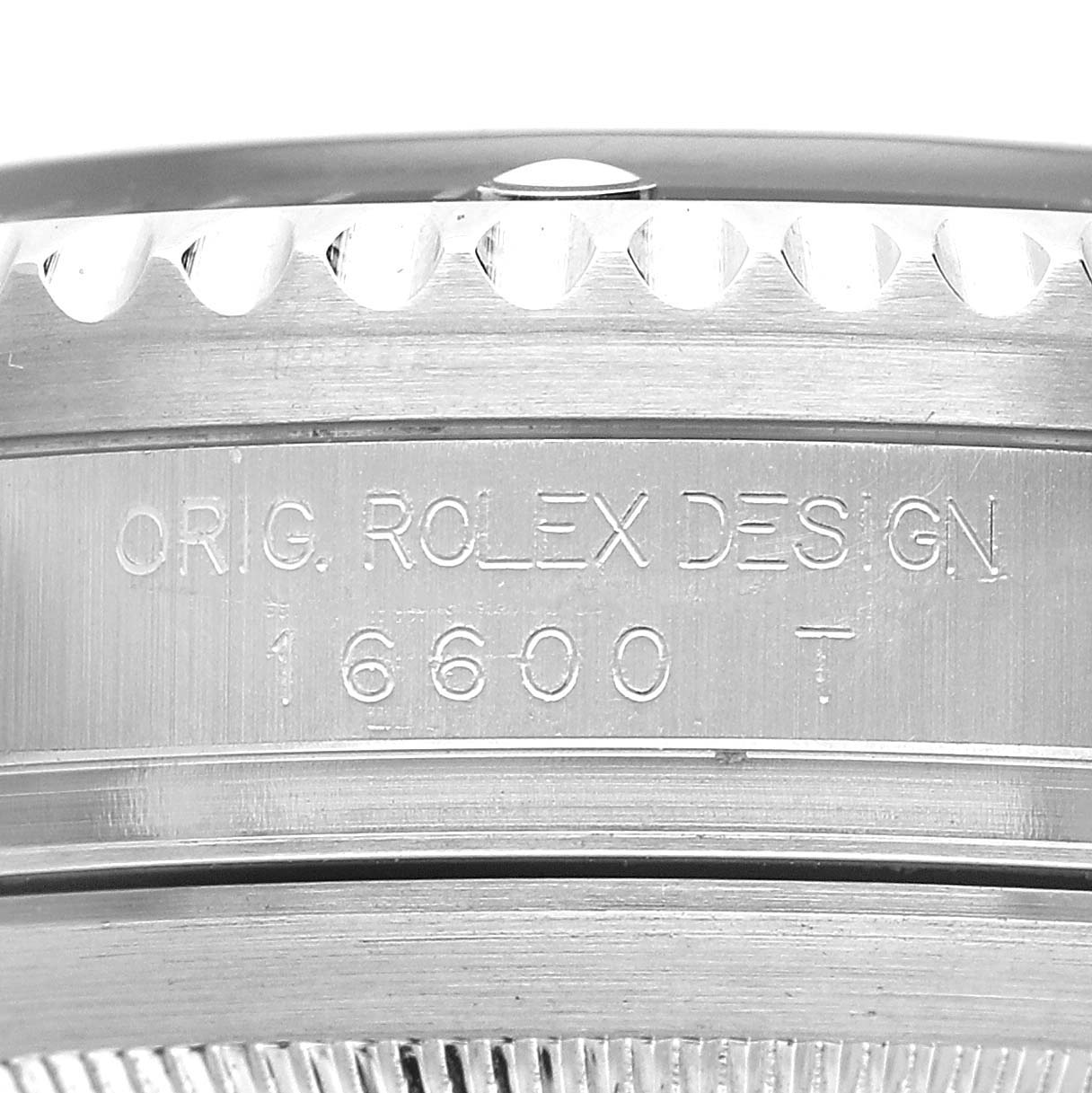 The image shows a close-up of the side of a Rolex Sea-Dweller M16600T Men's Stainless Steel Black Dial, highlighting the engraved model number "16600" and "ORIG. ROLEX DESIGN."