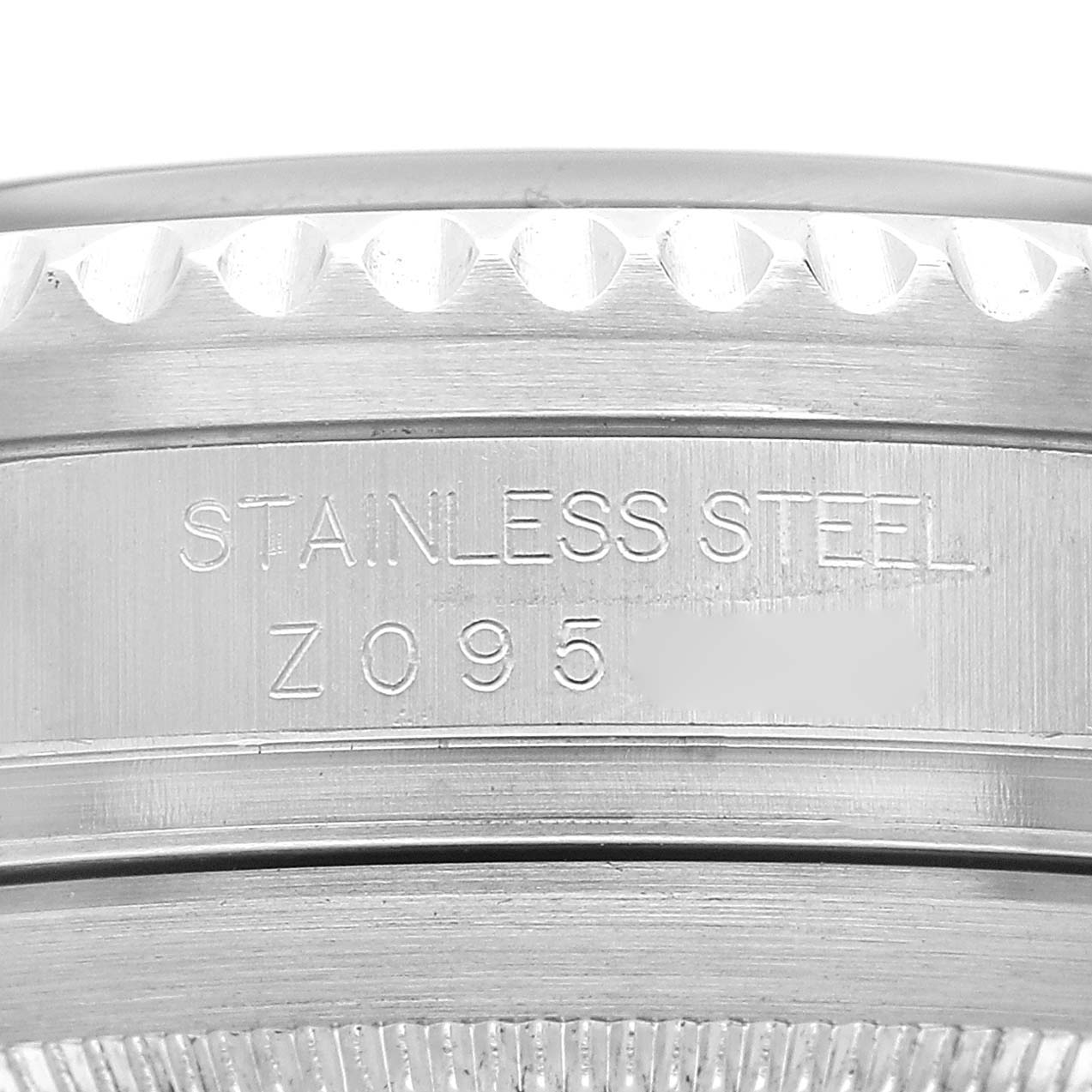 The image shows a close-up of the side of a Rolex Sea-Dweller M16600T Men's Stainless Steel Black Dial, focusing on the stainless steel part and engravings.