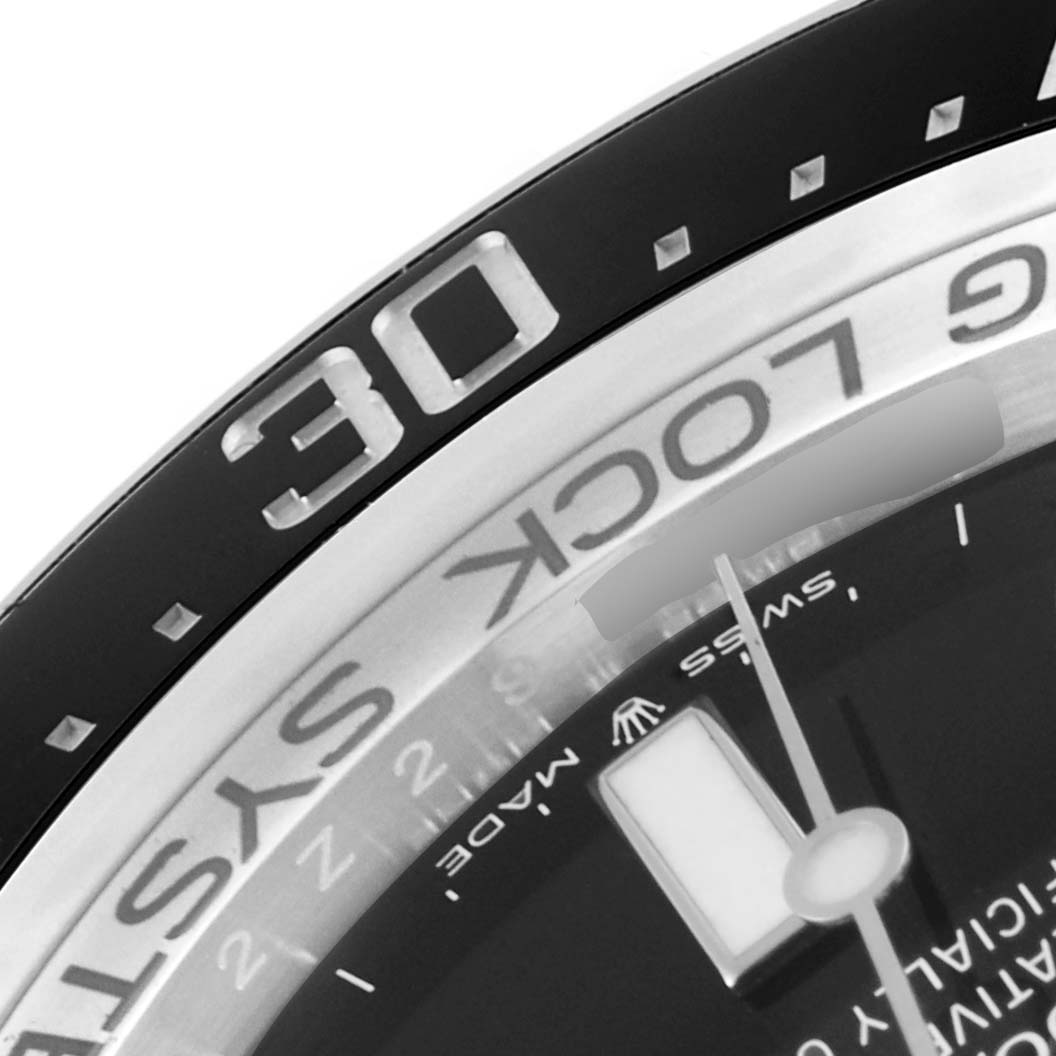 This close-up image of the Rolex Sea-Dweller 126660 Men
s Stainless Steel Black Dial 126660 Men
s Stainless Steel Black Dial watch shows part of the bezel, dial, and a portion of the hands.