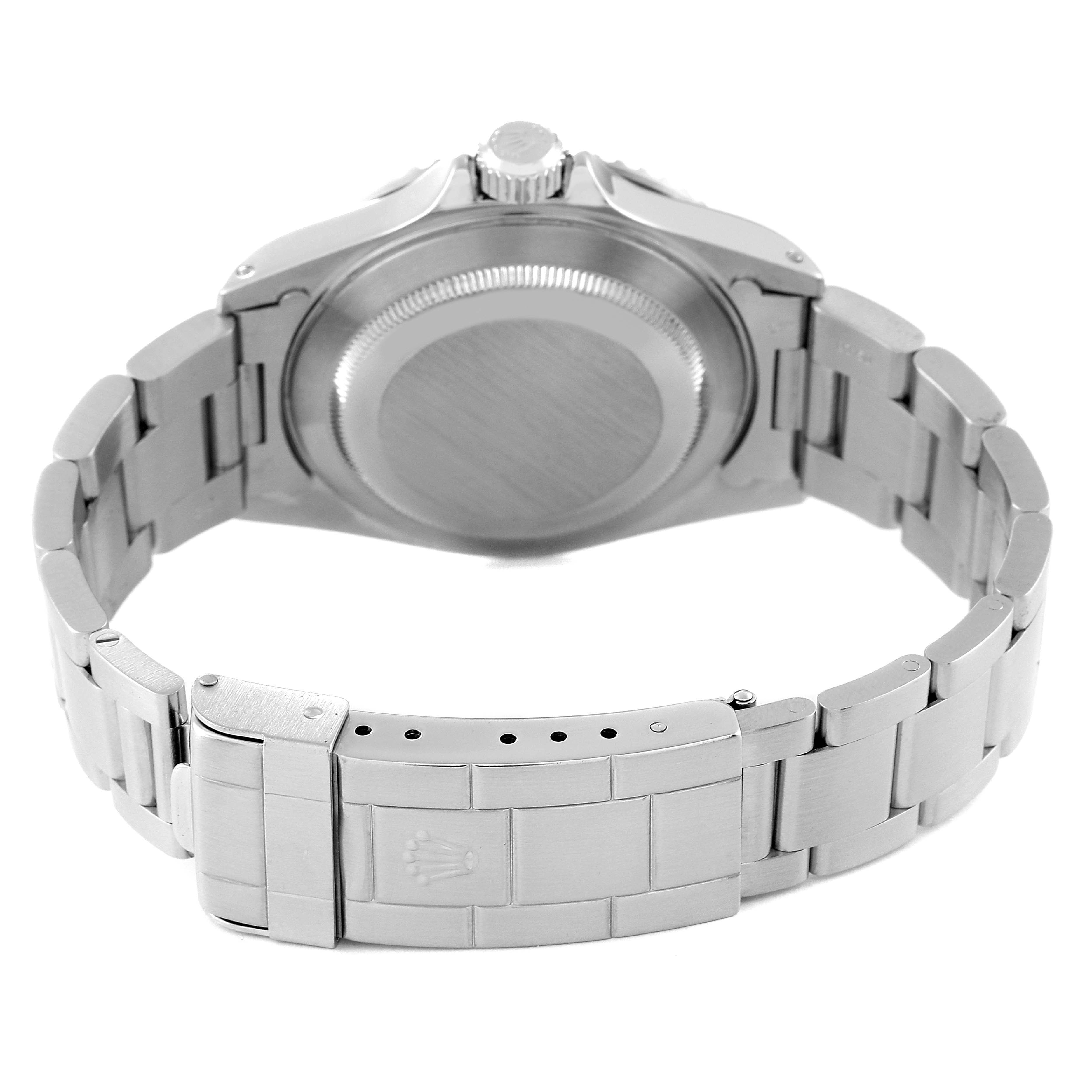 The image shows the rear view of a Rolex Submariner 14060 Men
s Stainless Steel Black Dial 14060 Men
s Stainless Steel Black Dial watch focusing on its case back and bracelet clasp.