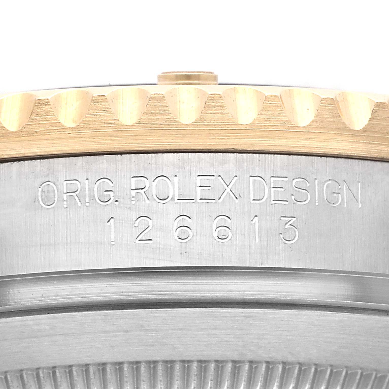 The image shows a close-up of the side of the Rolex Submariner M126613LN-0002 Men's Steel and Gold (two tone) Black Dial M126613LN-0002 Men's Steel and Gold (two tone) Black Dial case, displaying the engraved model number and original design mark.