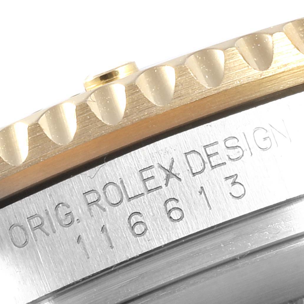 Close-up view of the bezel and engraved text of a Rolex Submariner 116613 Men's Stainless Steel Blue Dial 116613 Men's Stainless Steel Blue Dial watch.