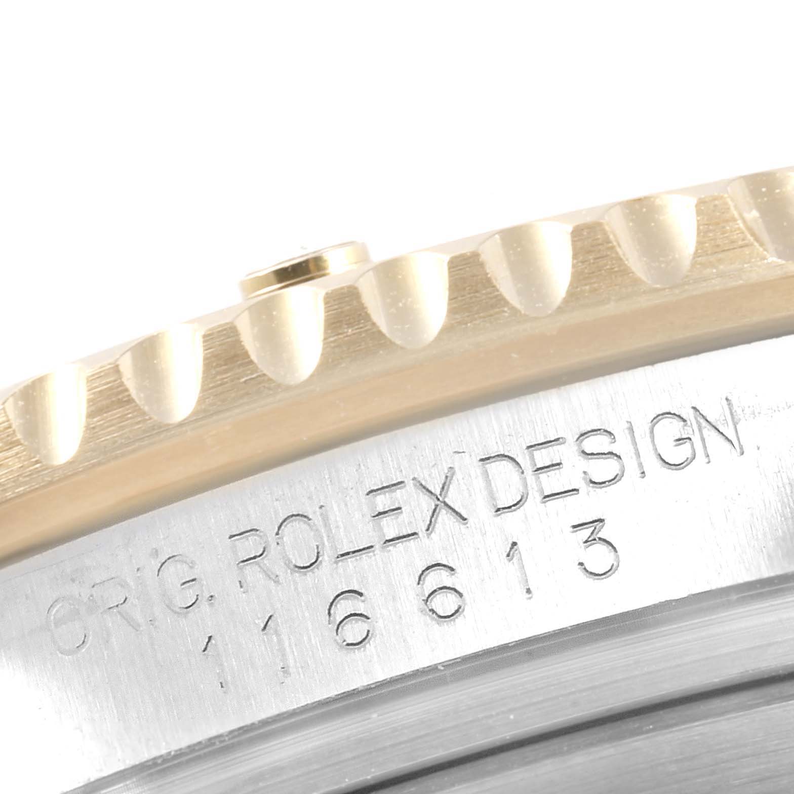 The image shows a close-up of the Rolex Submariner 116613 Men
s Stainless Steel Blue Dial 116613 Men
s Stainless Steel Blue Dial
s bezel and casing with "ORIG. ROLEX DESIGN 116613" engraved.