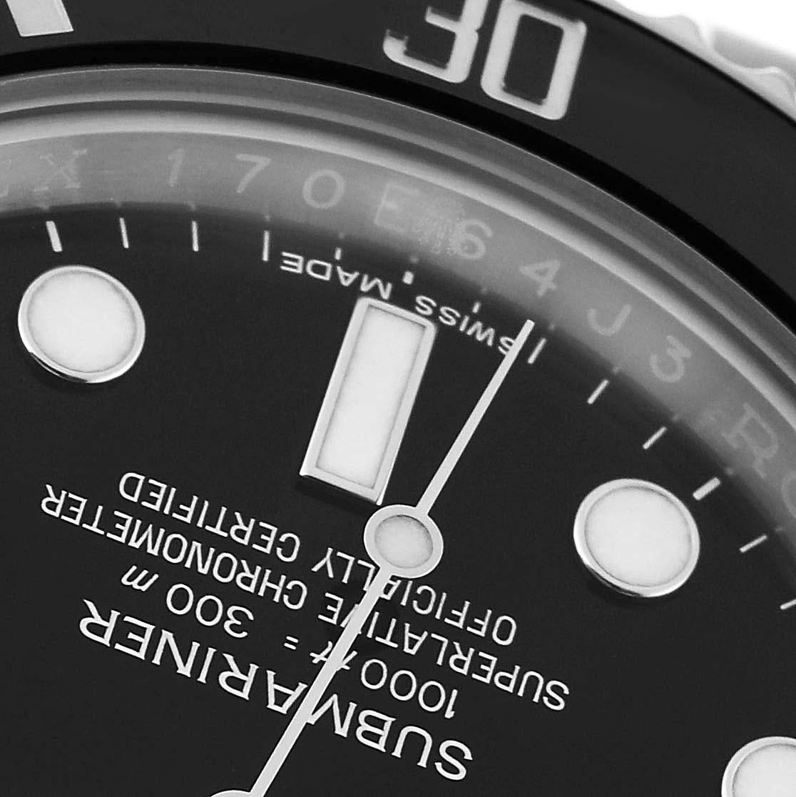 This close-up of the Rolex Submariner 116610LN Men
s Stainless Steel Black Dial 116610LN Men
s Stainless Steel Black Dial watch shows part of the dial and bezel, including hour markers and part of the minute hand.