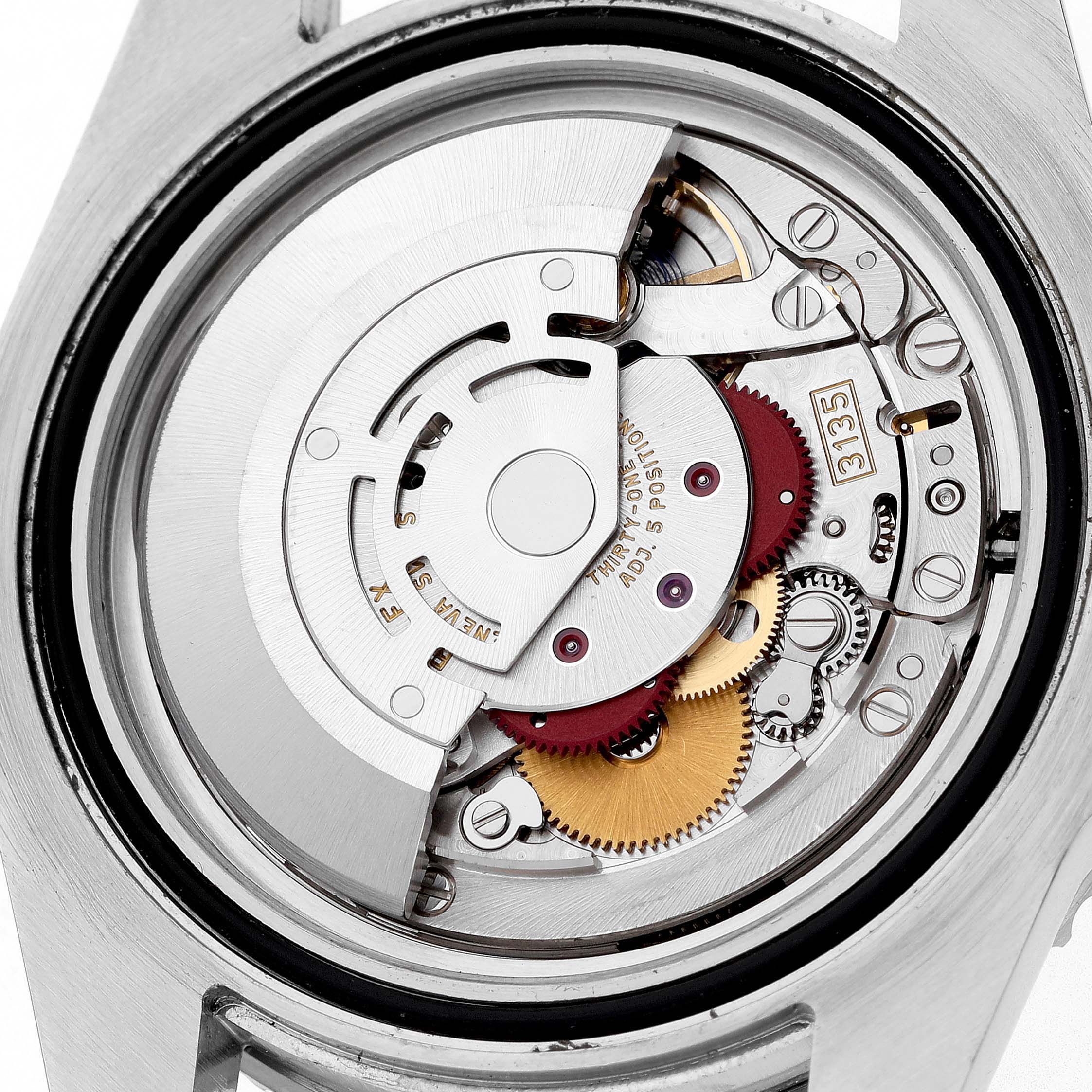 The image shows a close-up view of the Rolex Submariner 116610LN Men's Stainless Steel Black Dial's movement, displaying gears and components in detail.