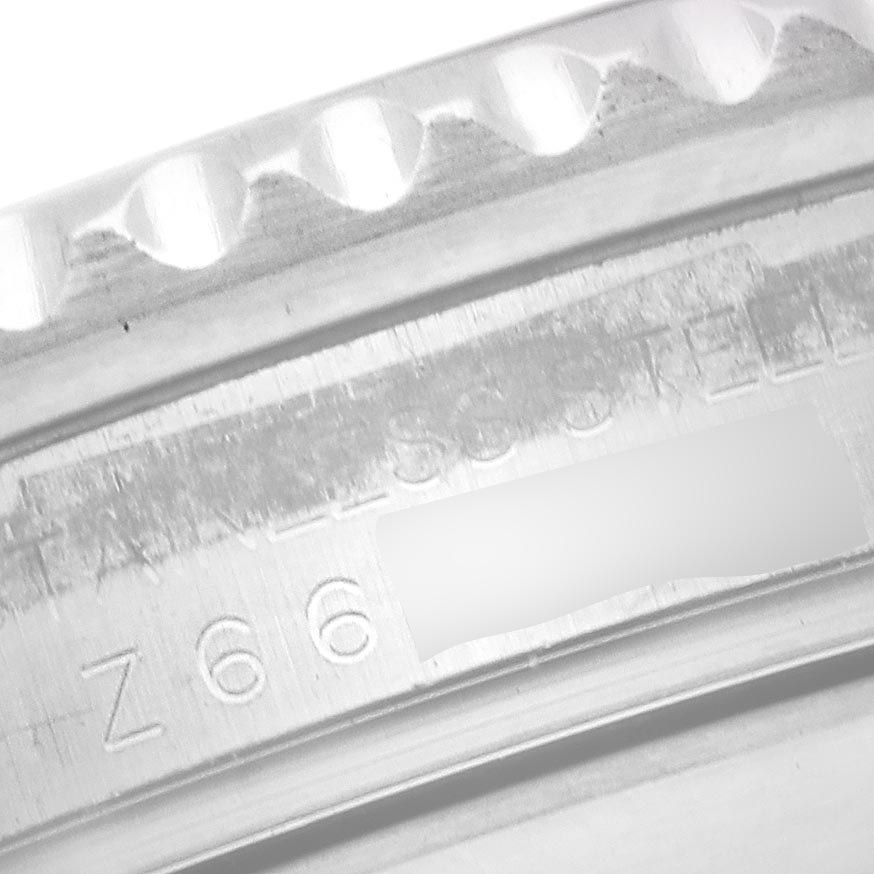 The image shows a close-up of the engraved inner bezel and markings of a Rolex Submariner 16610 T Men's Stainless Steel Black Dial 16610 T Men's Stainless Steel Black Dial watch.